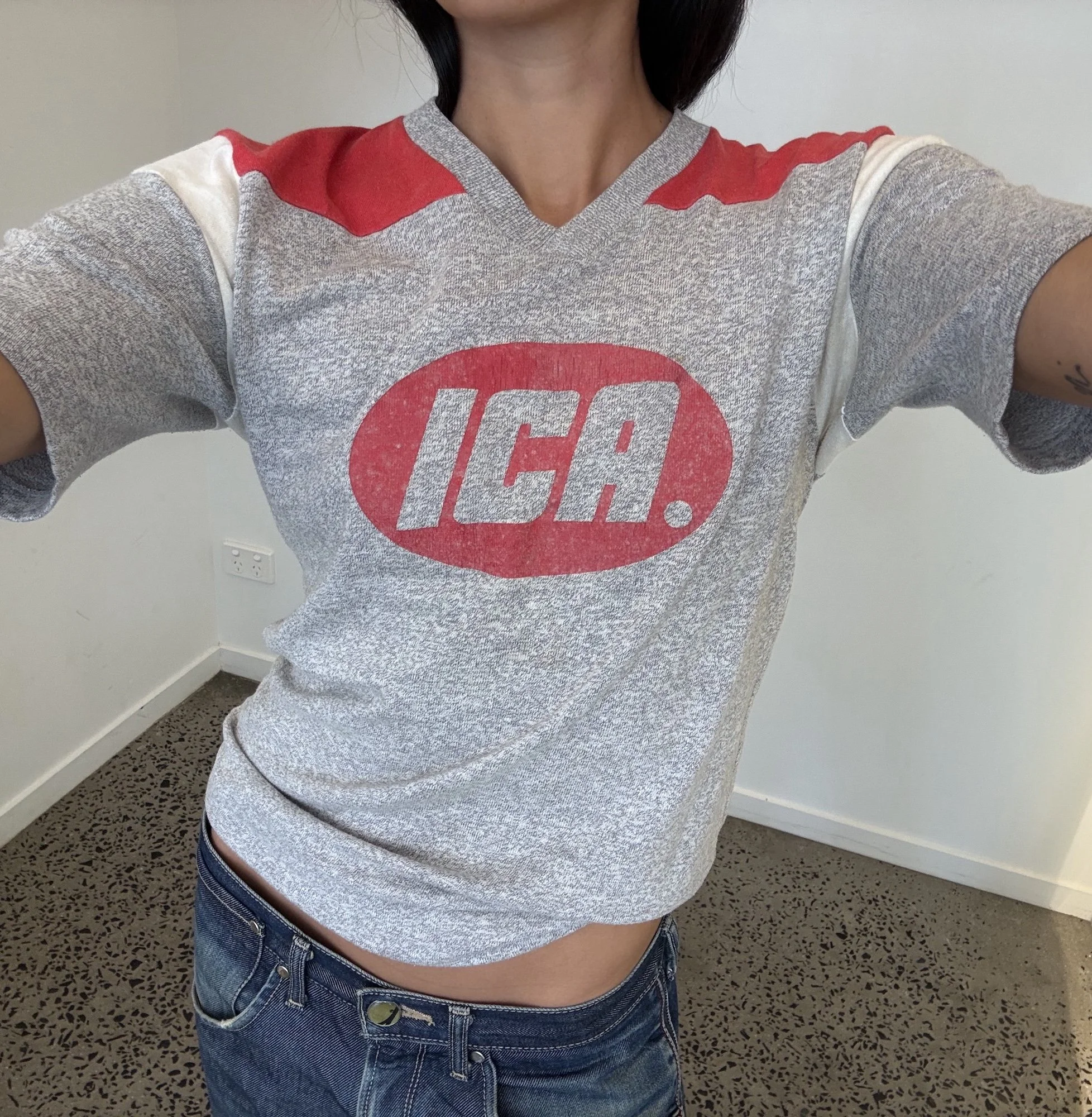 Vintage grey ICA jersey t-shirt showing red oval logo print across the chest