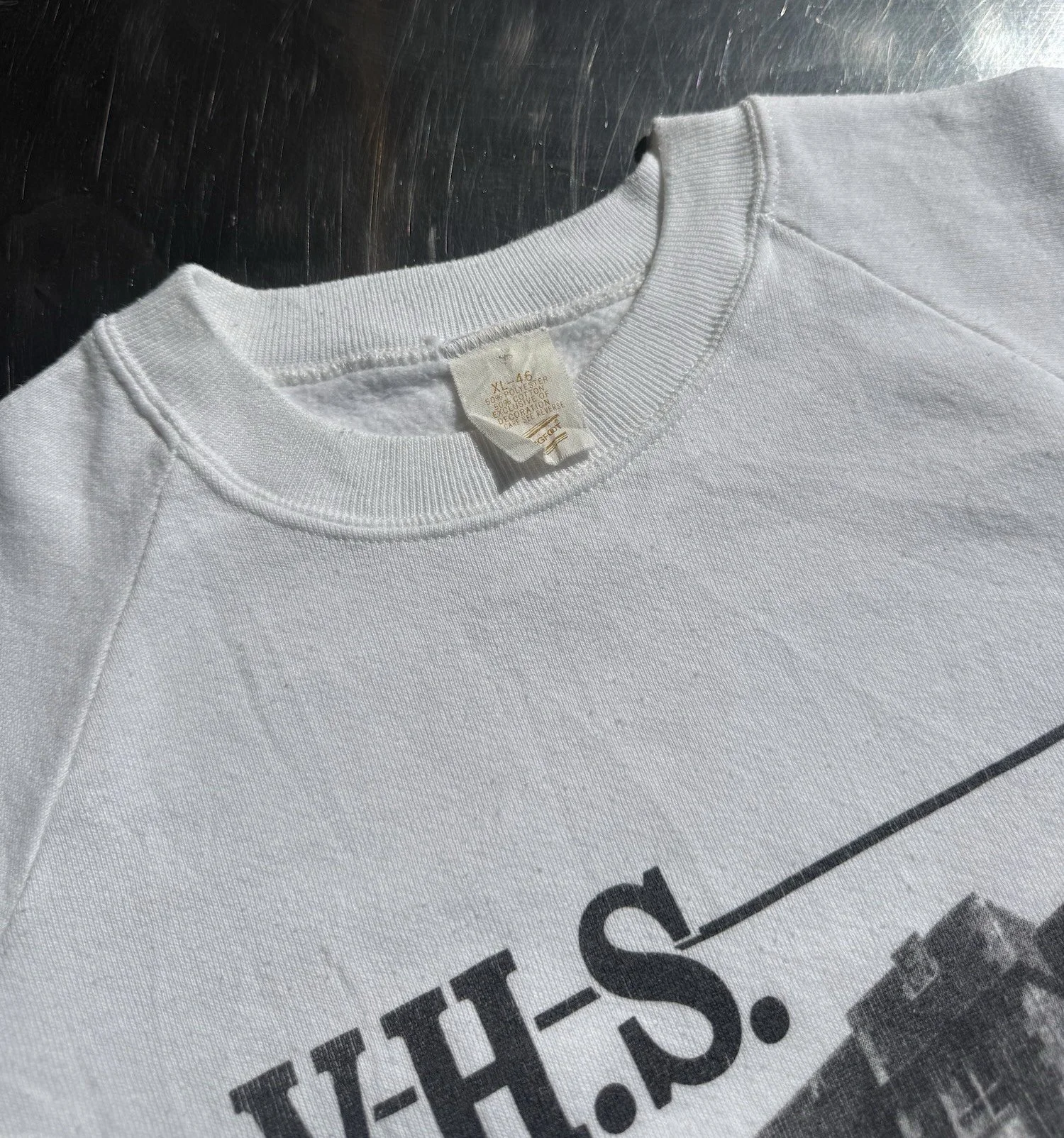 Ribbed cuff and hem detail on vintage white V.H.S. school raglan sweatshirt