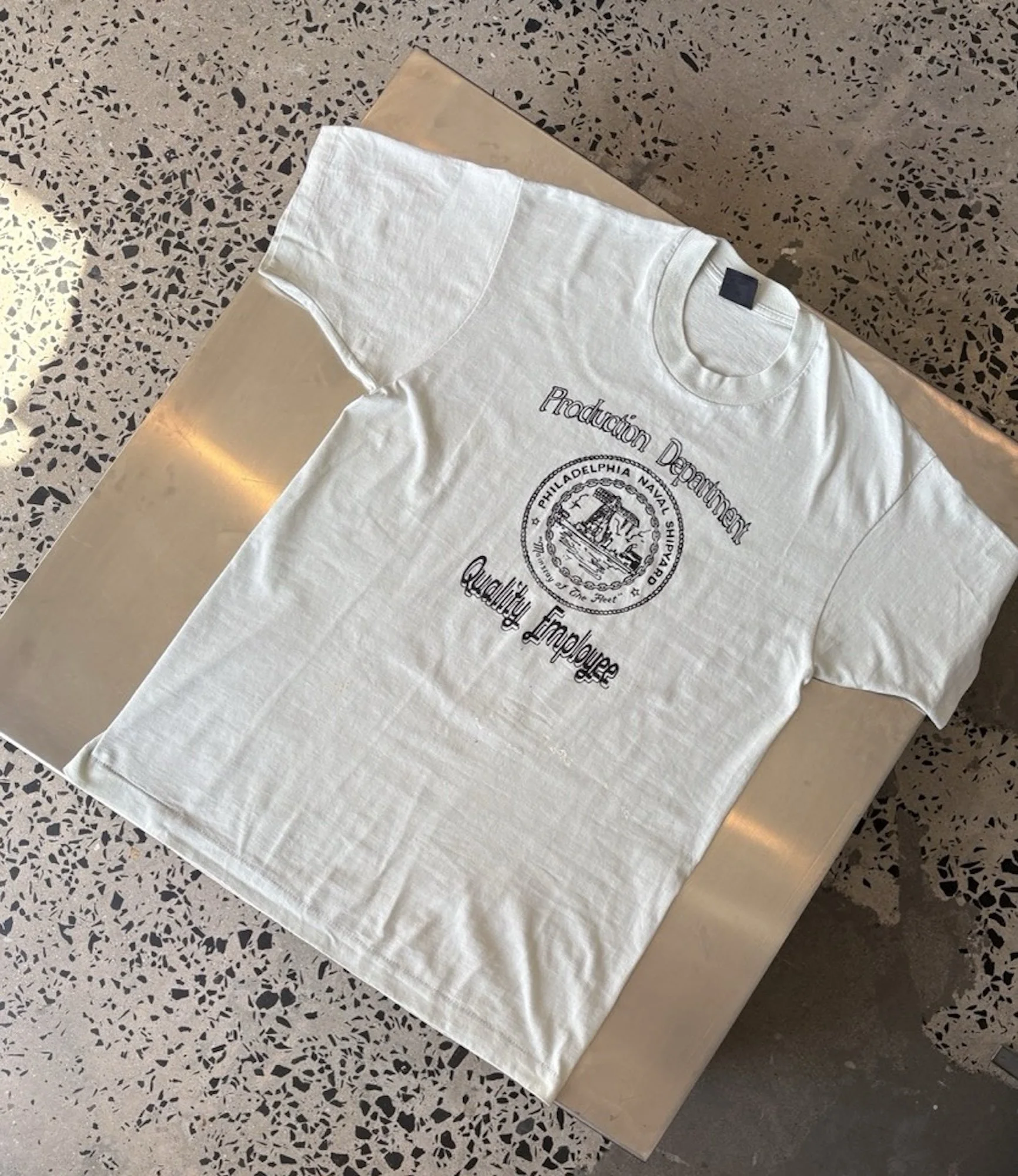 Vintage white Philadelphia Naval Shipyard t-shirt laid flat, full front view