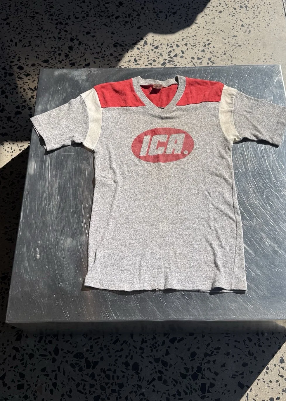 Champion Vintage grey and red ICA jersey t-shirt laid flat, front view