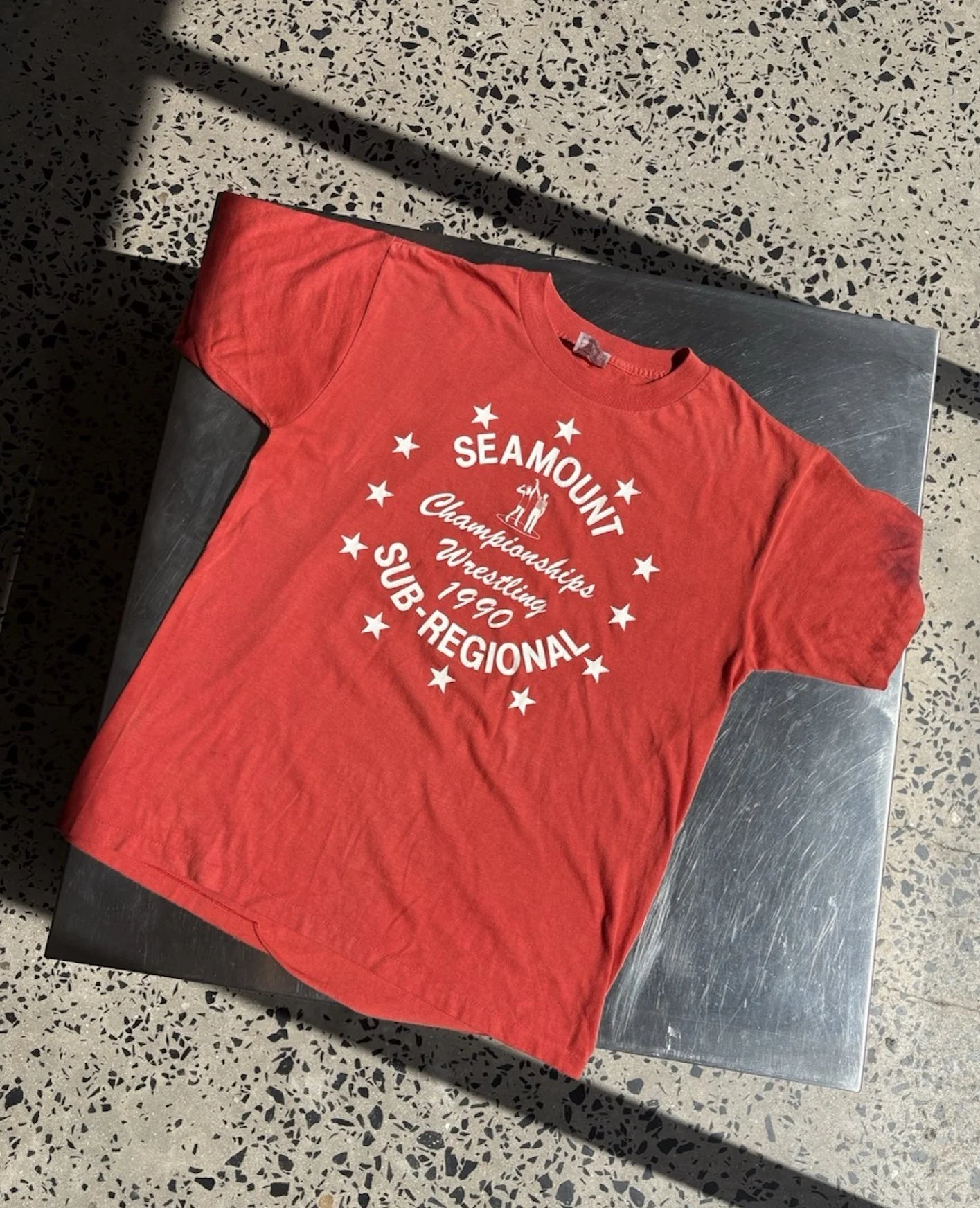 Vintage faded red Seamount Wrestling t-shirt laid flat, full front view