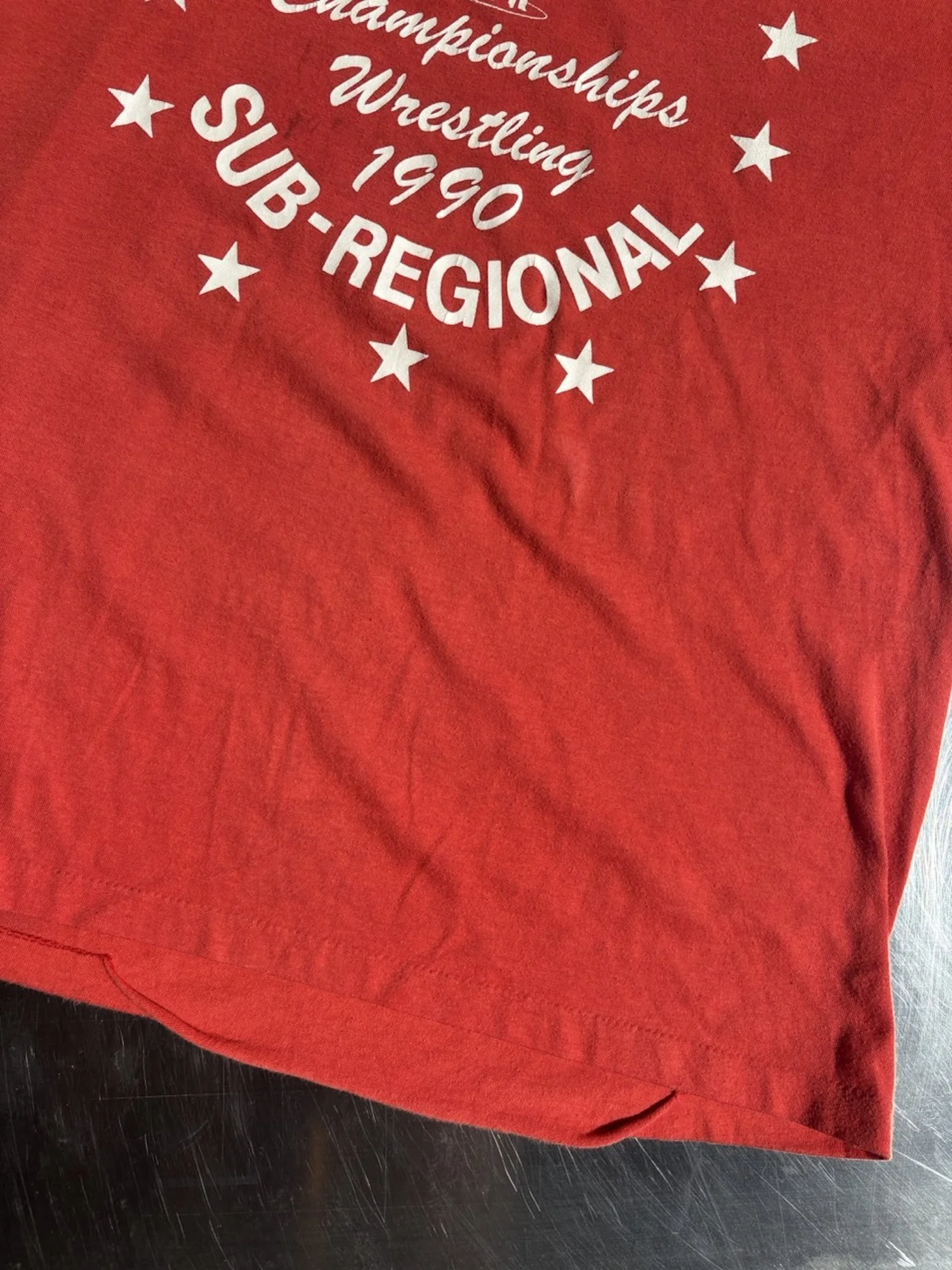 Single stitch hem detail on vintage faded red Seamount Wrestling t-shirt