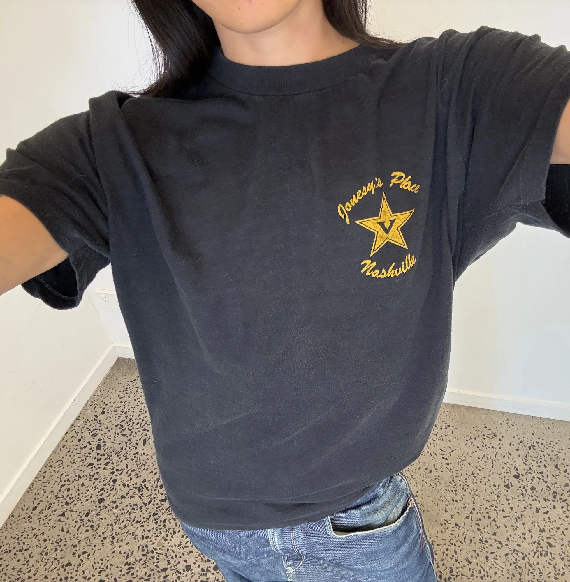 Vintage faded black Jonesy's Place Nashville t-shirt showing yellow star logo on the chest