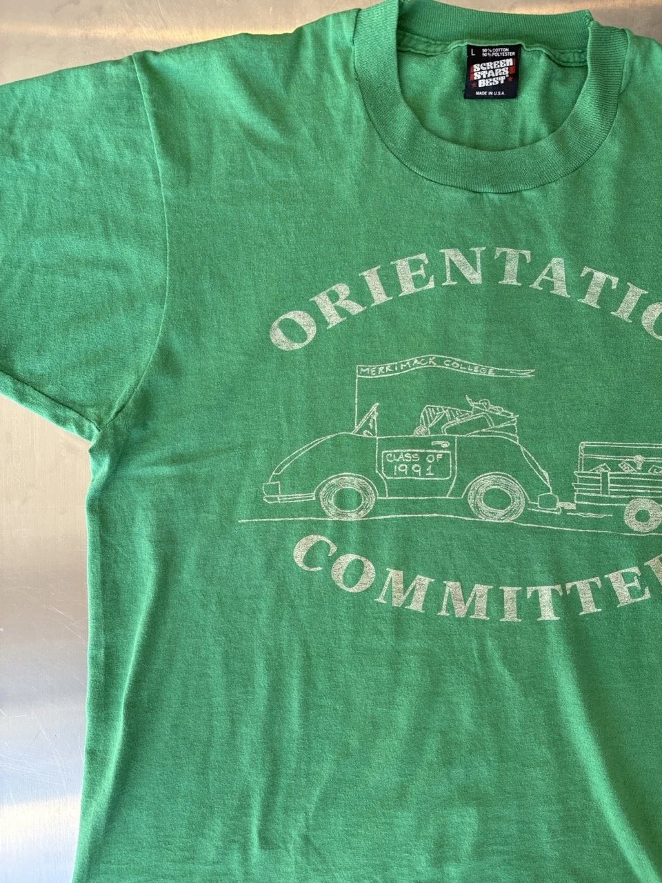 Close-up of front print and Screen Stars Best neck label on vintage green t-shirt