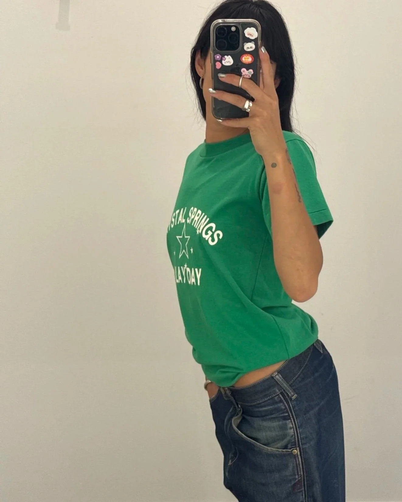 Model wearing a vintage green Crystal Springs Play Day t-shirt, side view