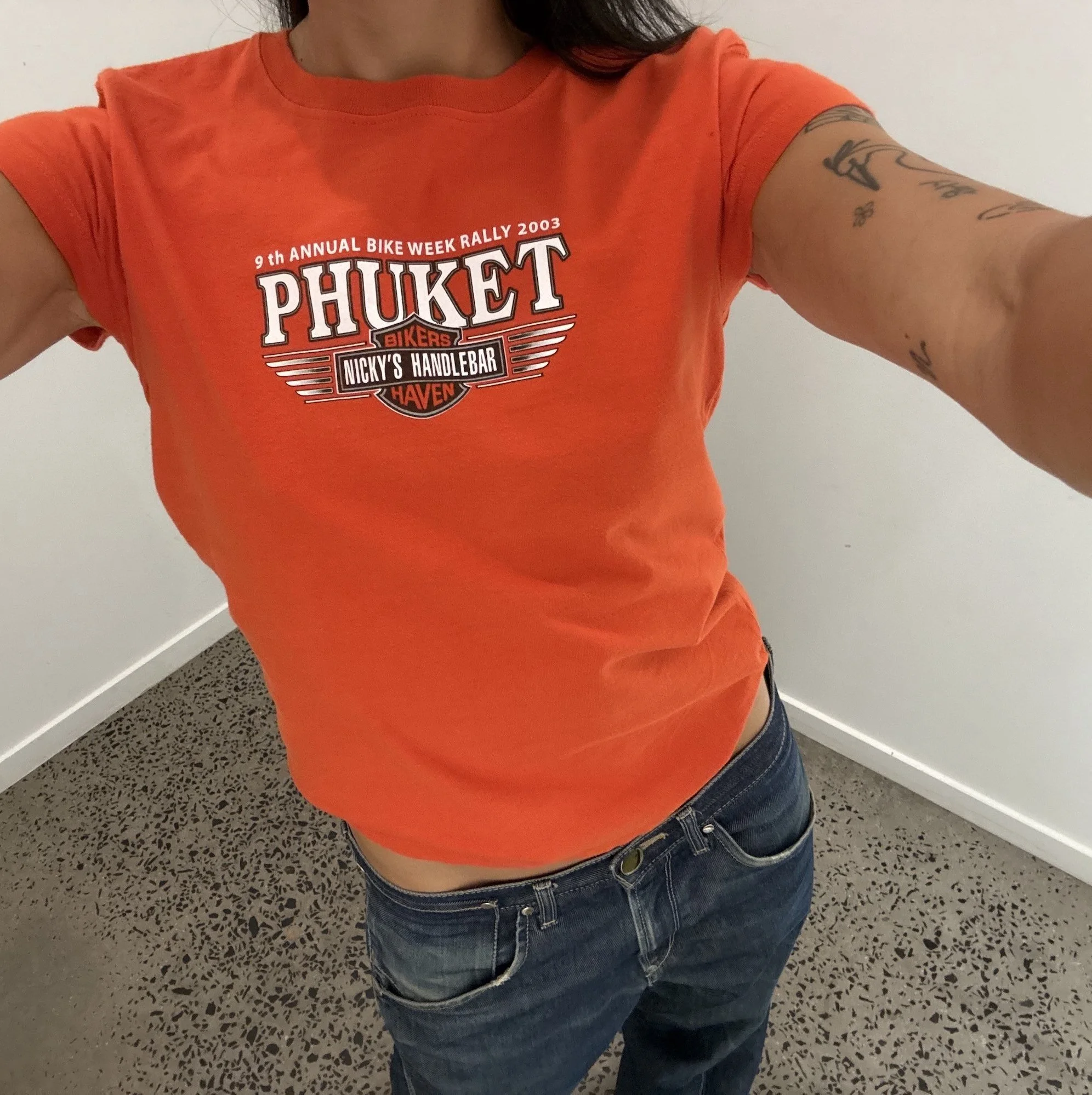 Vintage orange Phuket Bike Week t-shirt showing winged badge print across the chest