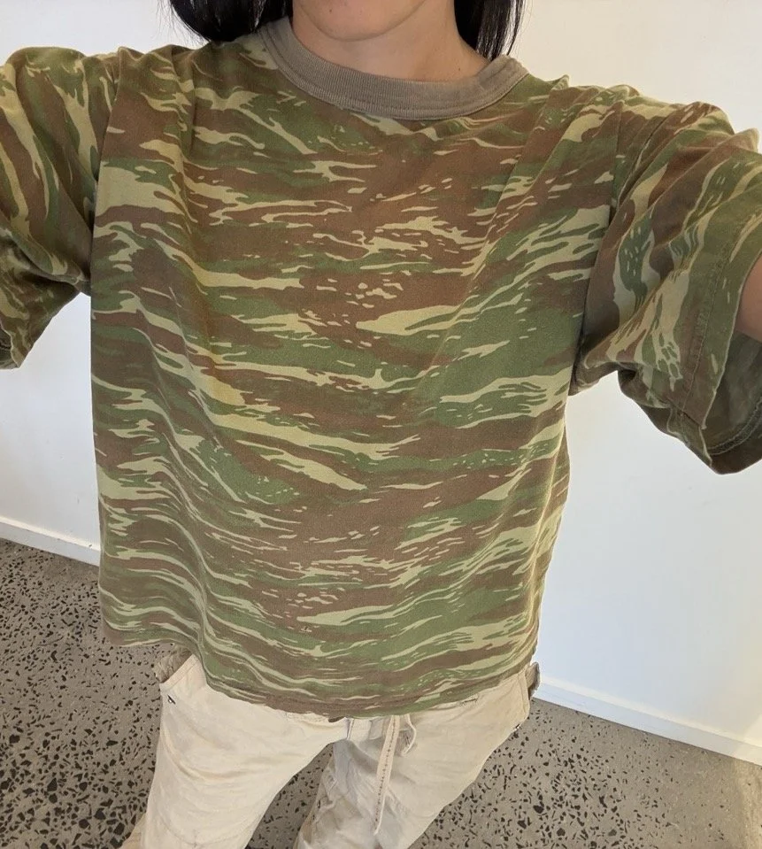 Vintage camo t-shirt showing green, brown and sand streaked pattern across the chest