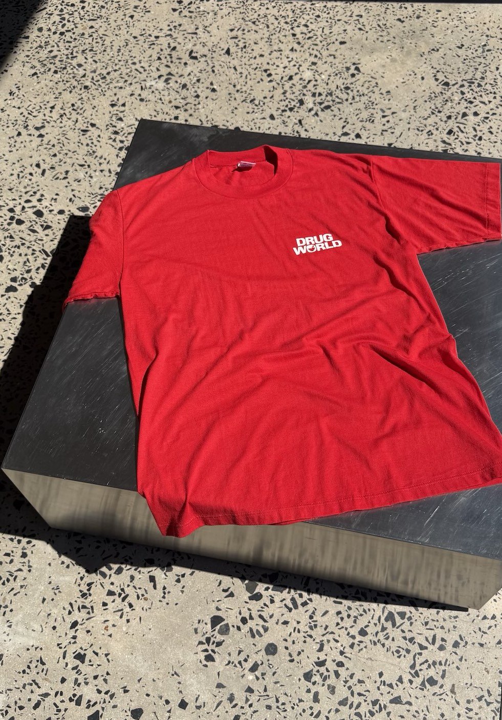 Vintage red Drug World t-shirt laid flat, full front view