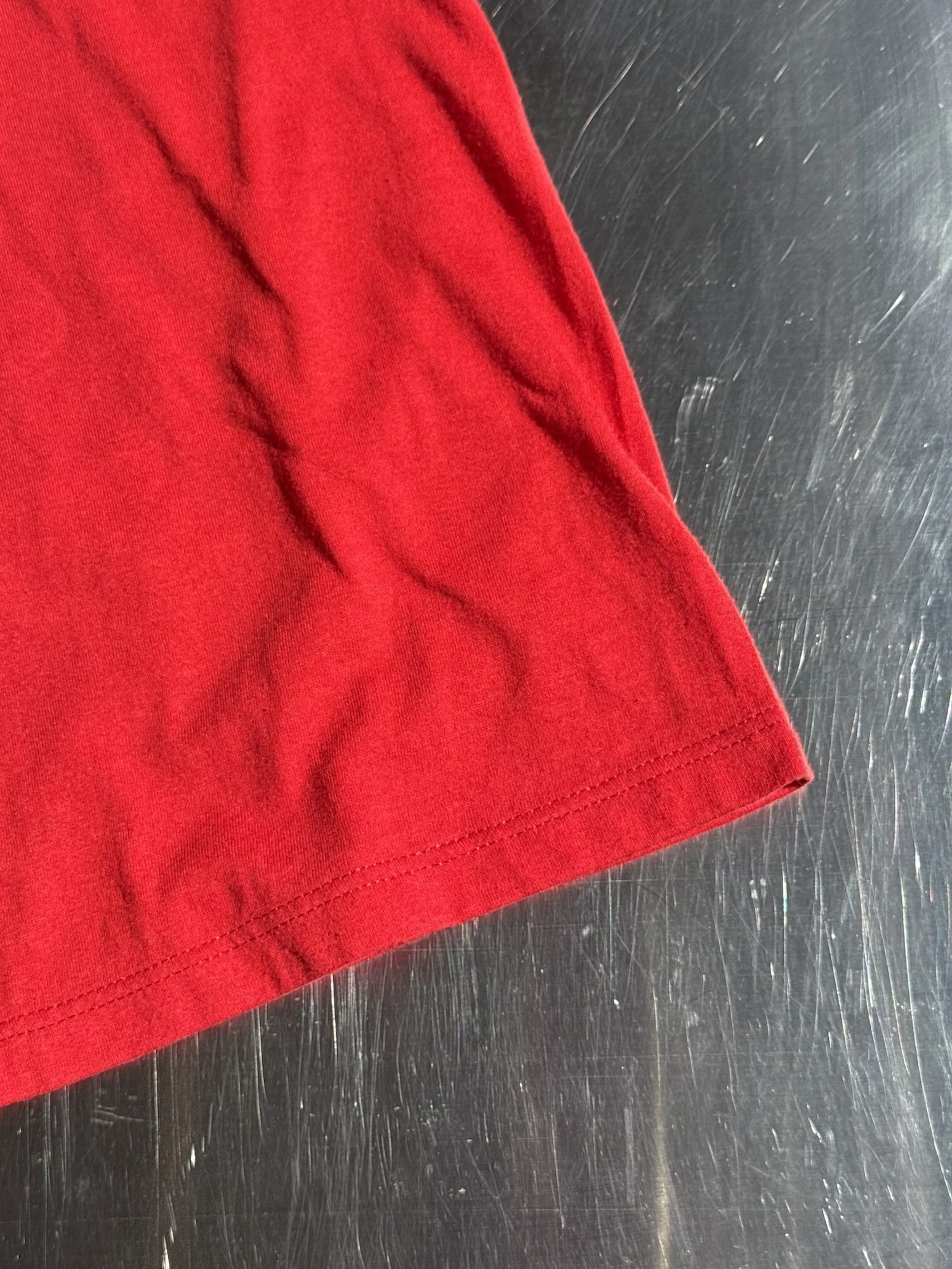 hem detail on vintage red Drug World t-shirt