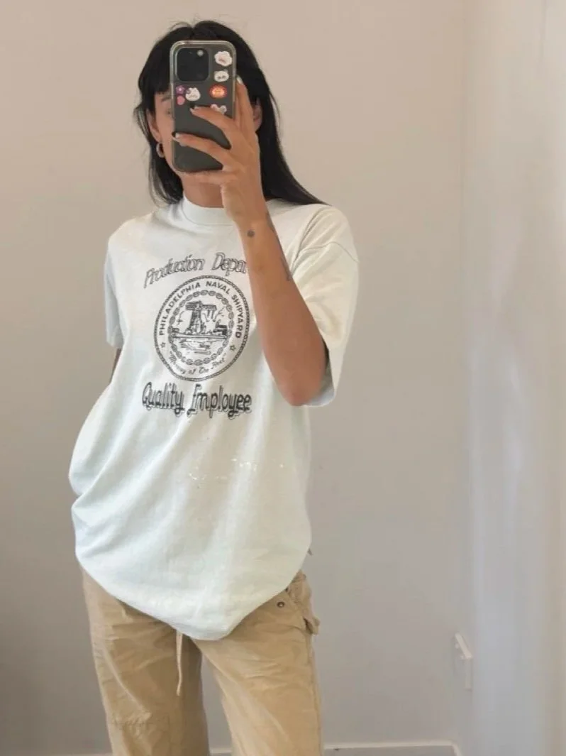 Model wearing a vintage Philadelphia Naval Shipyard t-shirt in white, front view