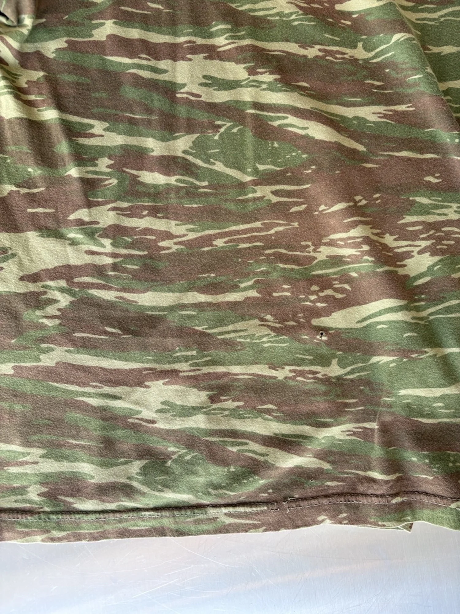 Small hole at the lower front of vintage camo t-shirt