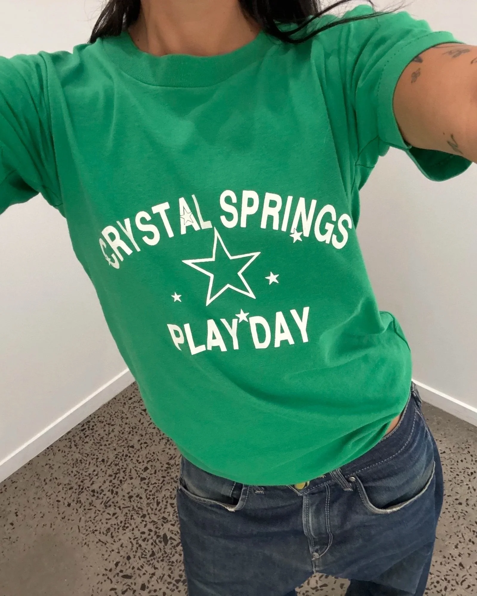 Vintage green Crystal Springs Play Day t-shirt showing white arched lettering and star print