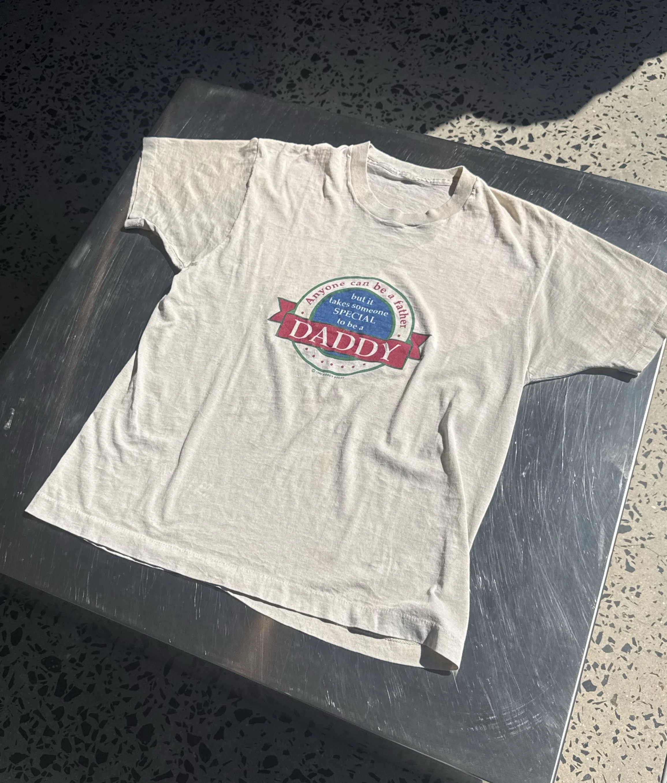 Vintage 90s cream Daddy t-shirt laid flat showing full front print