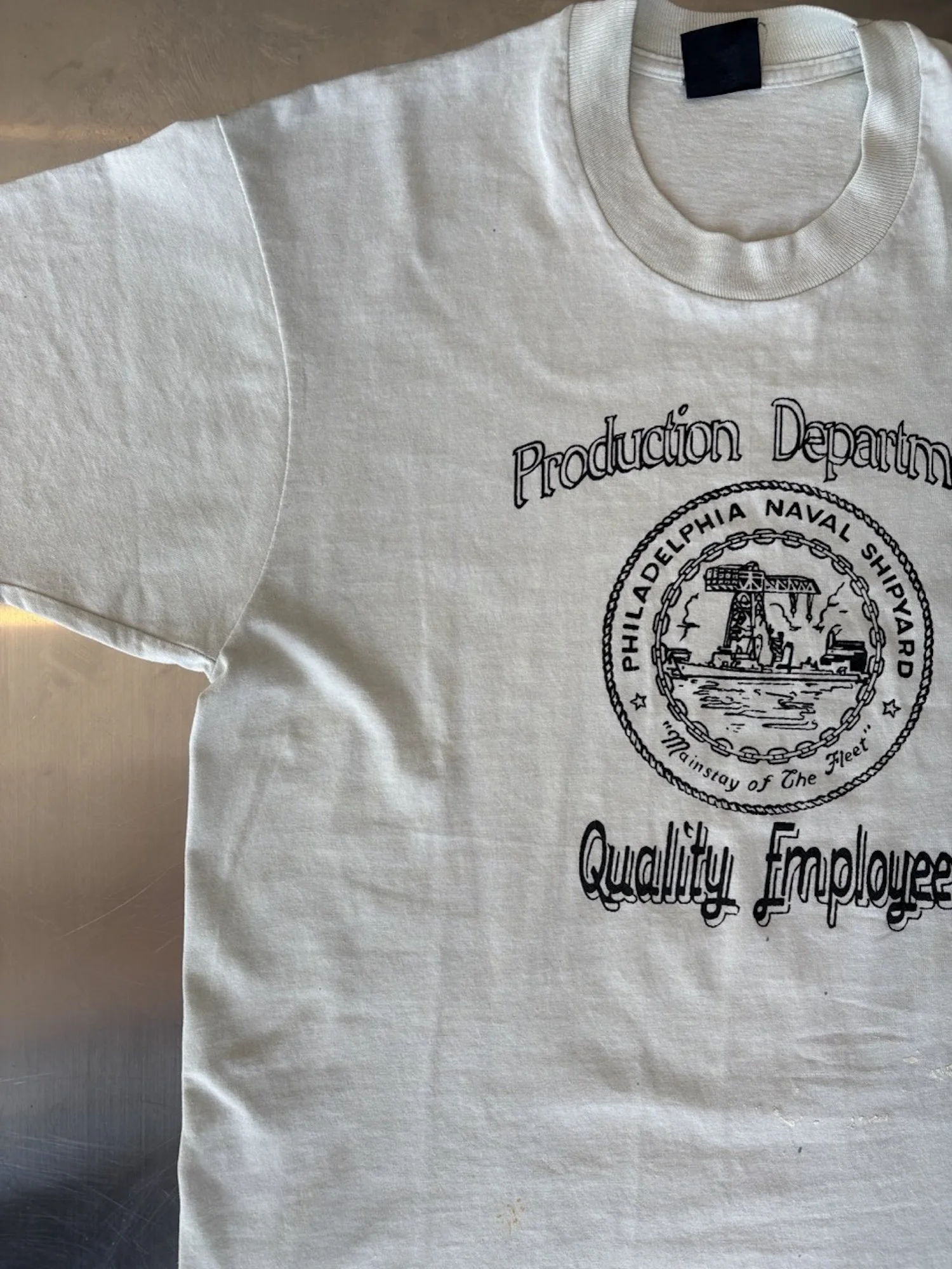 Close-up of Philadelphia Naval Shipyard seal and Quality Employee lettering on vintage white t-shirt