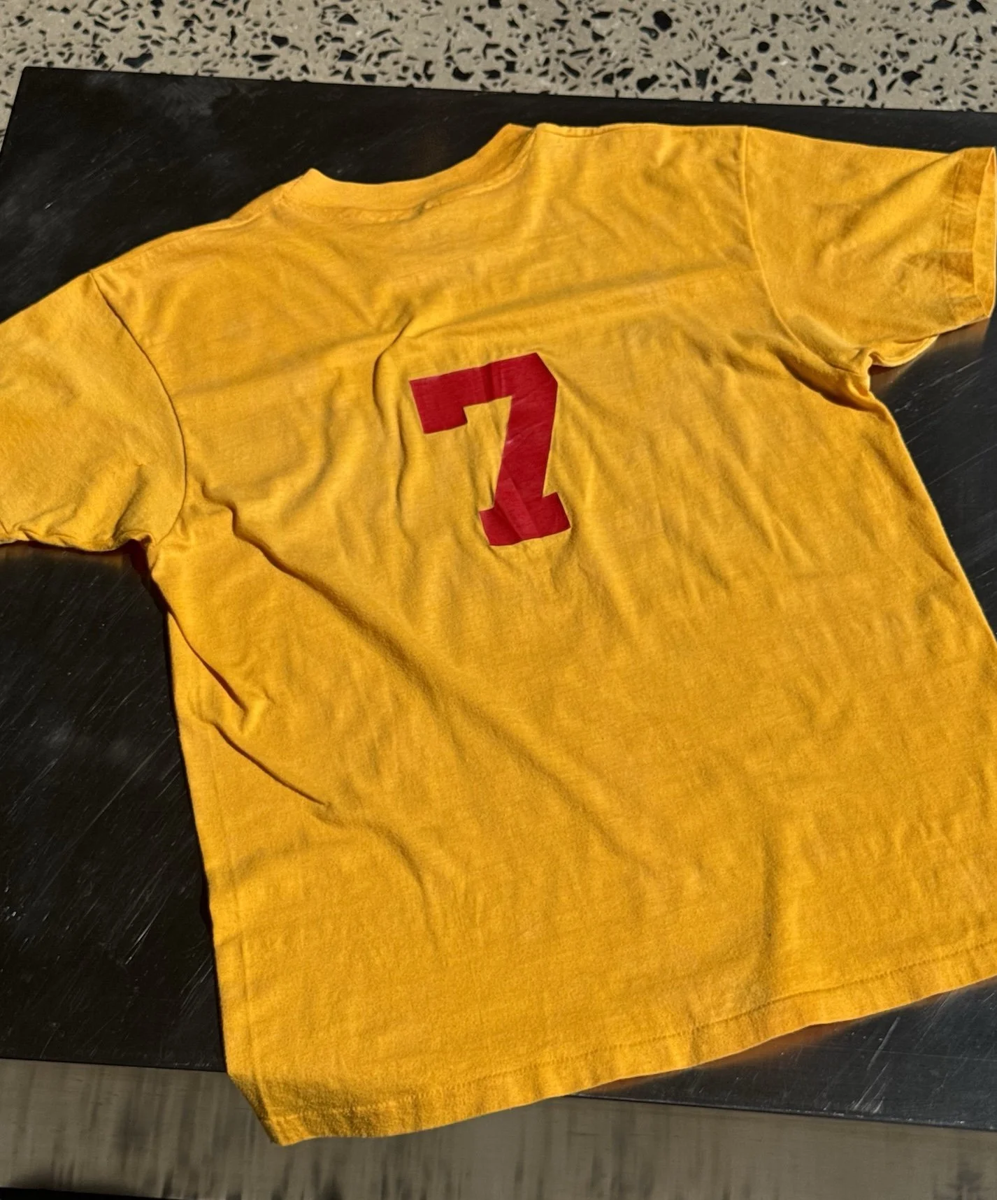 Back of vintage 80s yellow Injectronics t-shirt showing red number 7 graphic