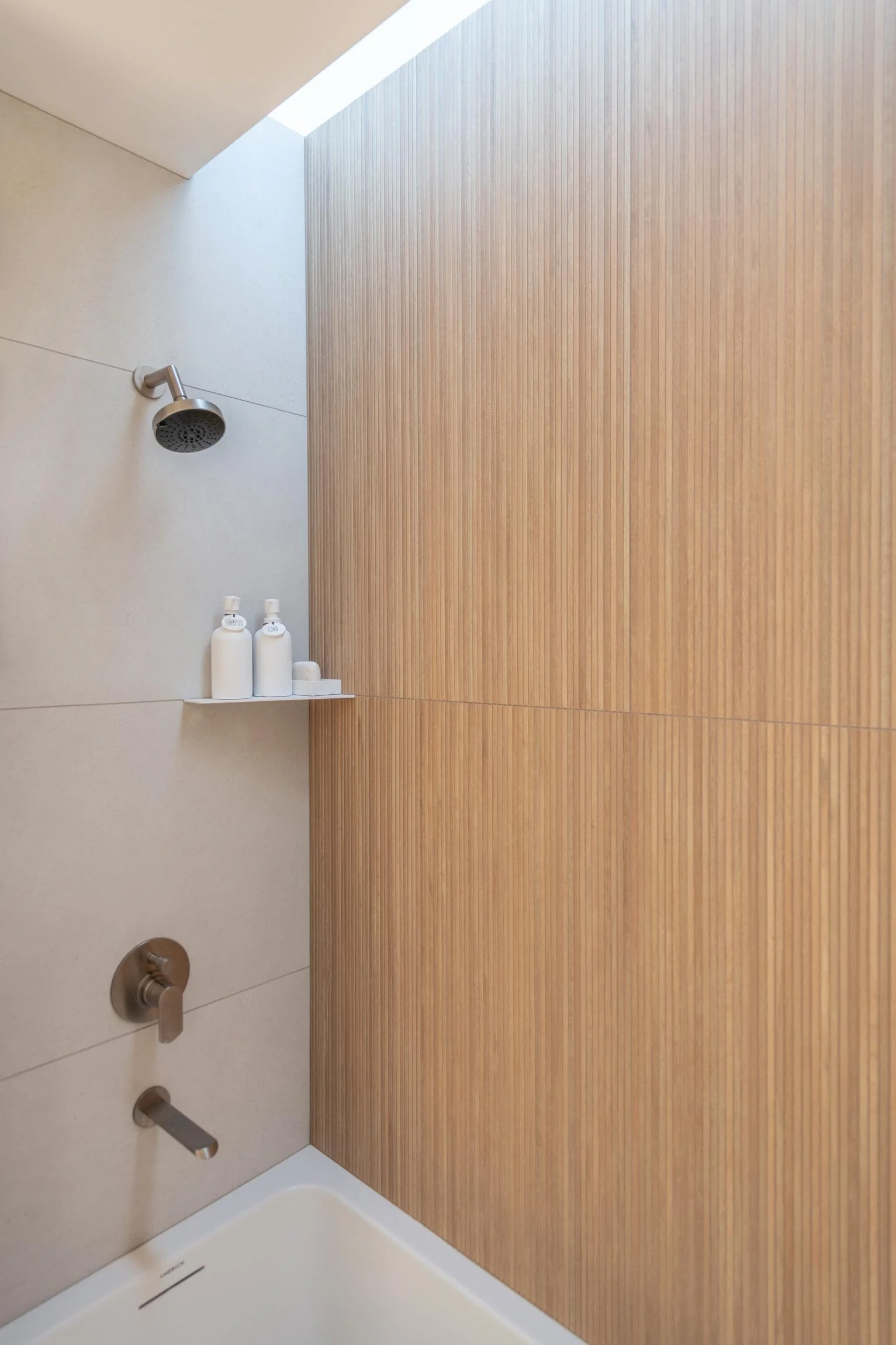 Inside shower with tile and wood slat walls