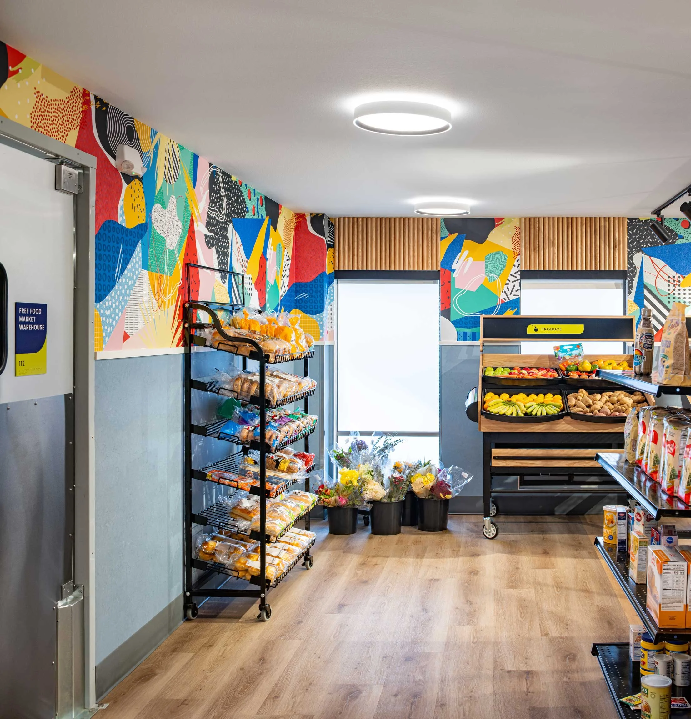 Food pantry with branded signage and colorful wallpaper