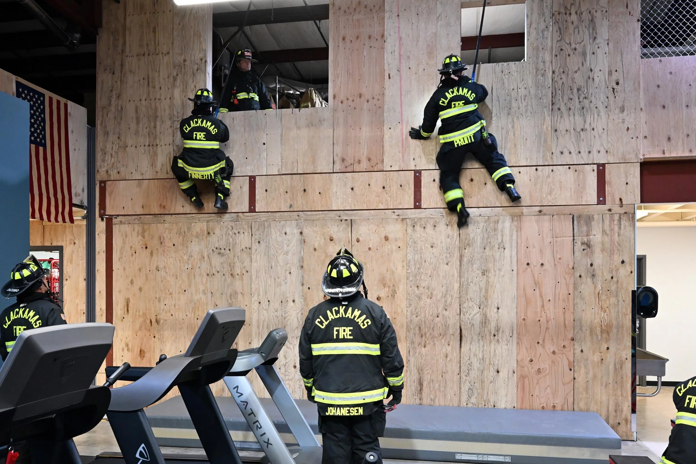 Firemen training on mock wall for rescues