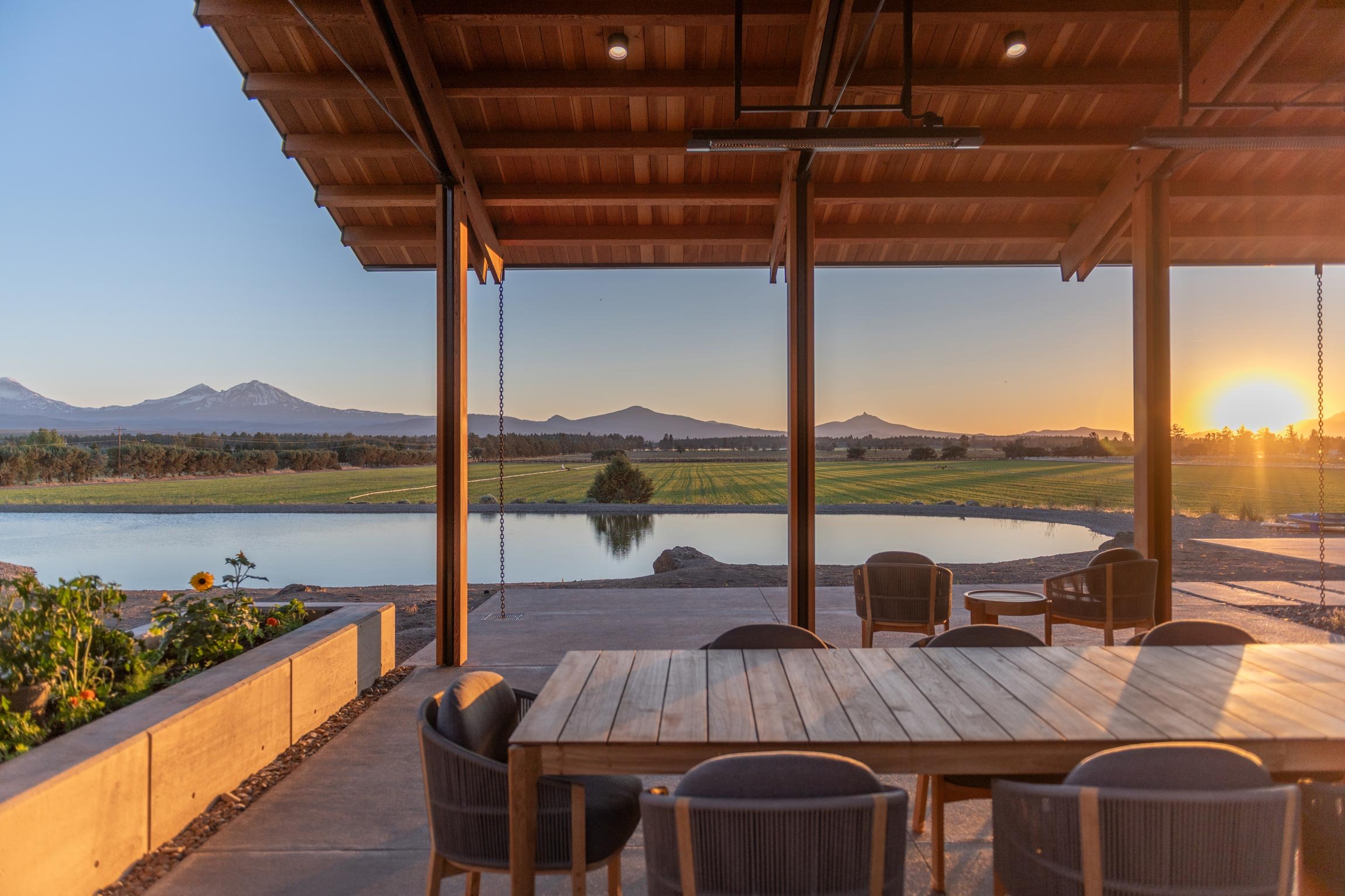 Sunset view of mountains and pond from covered patio