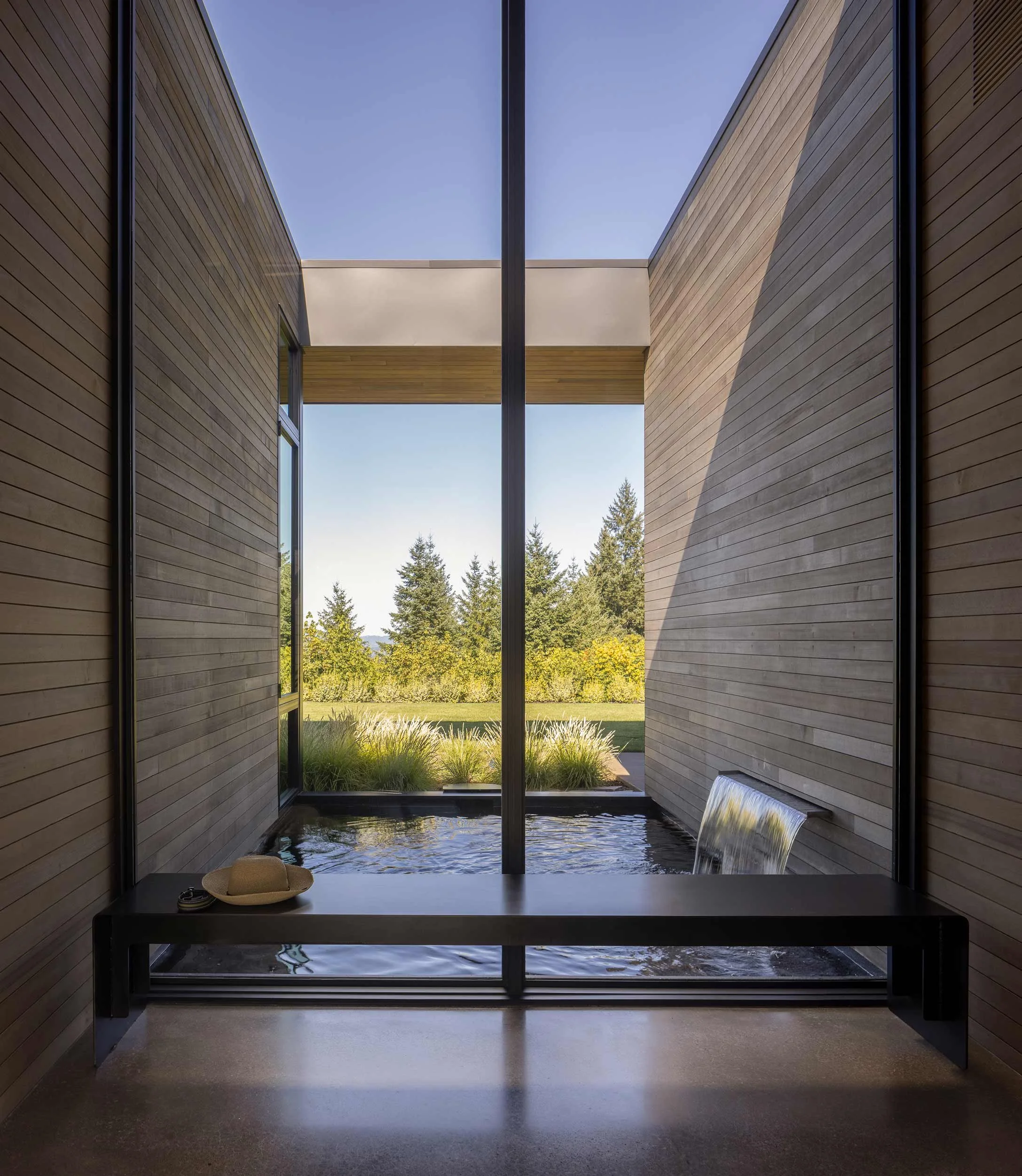 View of a exterior koi pond and water feature from inside