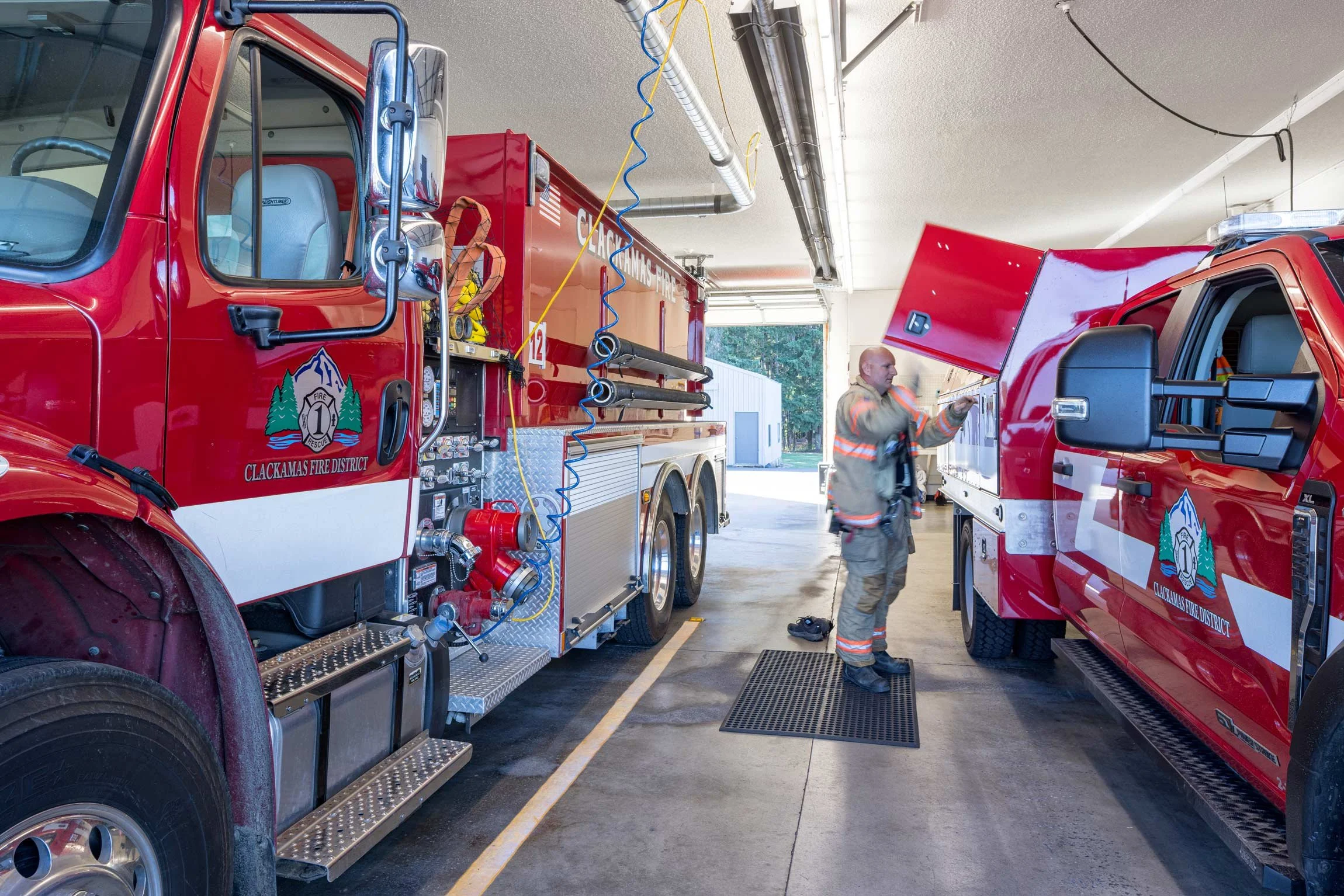 Fireman at a fire truck in the bay