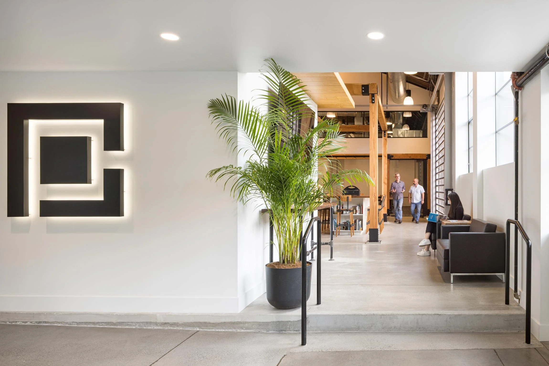 Entry to office with view of office and P&C logo on the wall