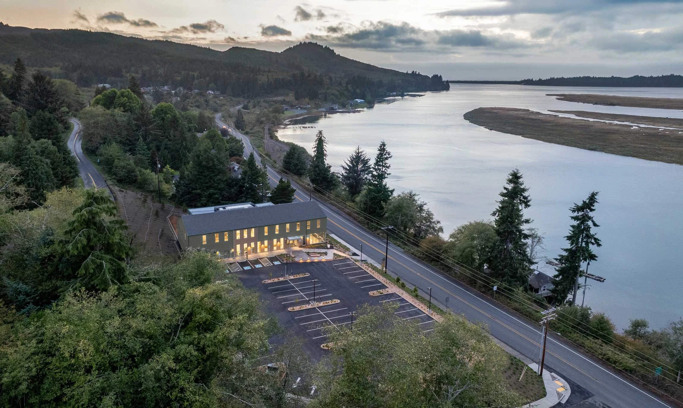 Aerial dusk shot of building facing bay