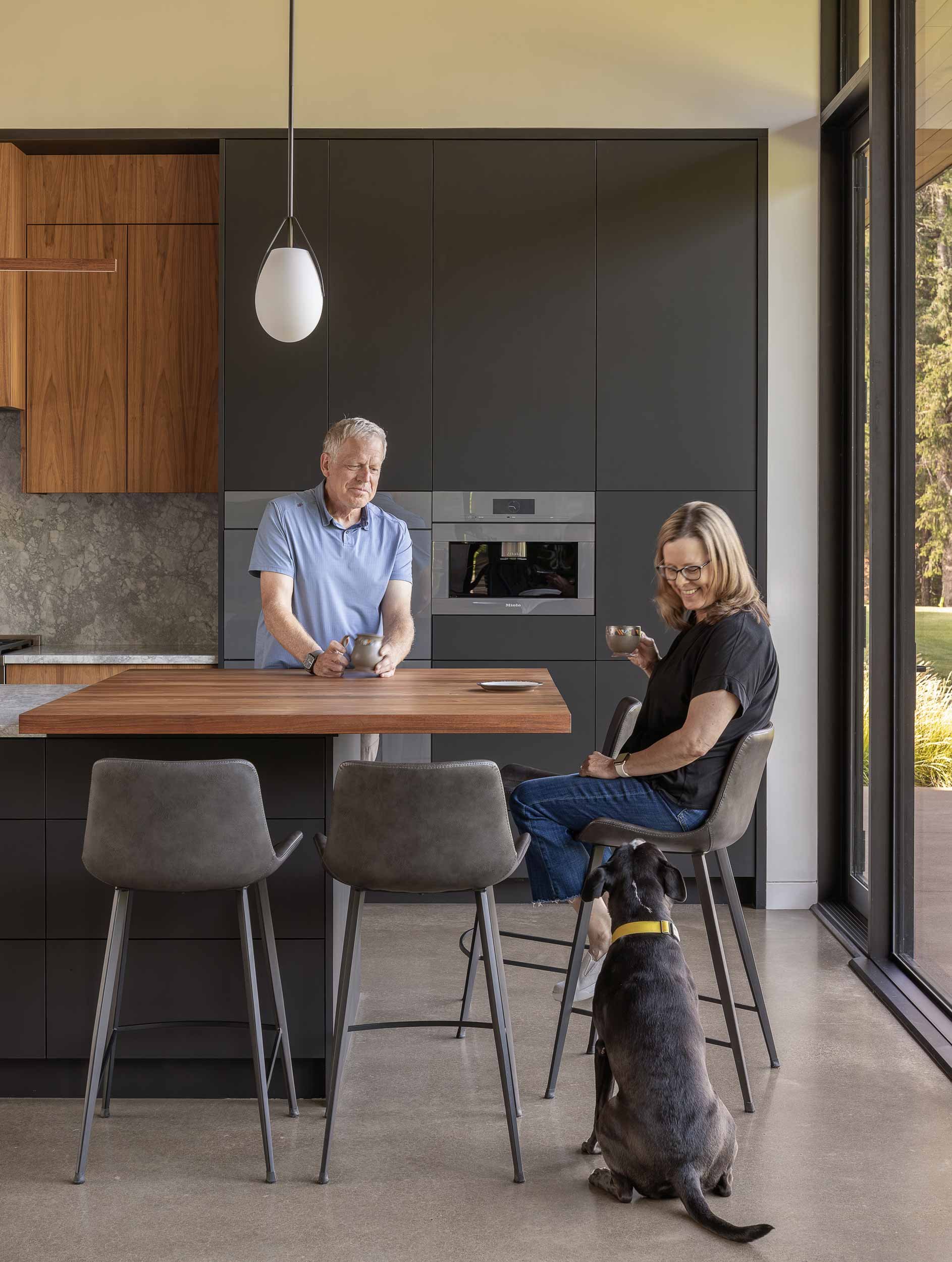 Couple sitting at stools in kitchen