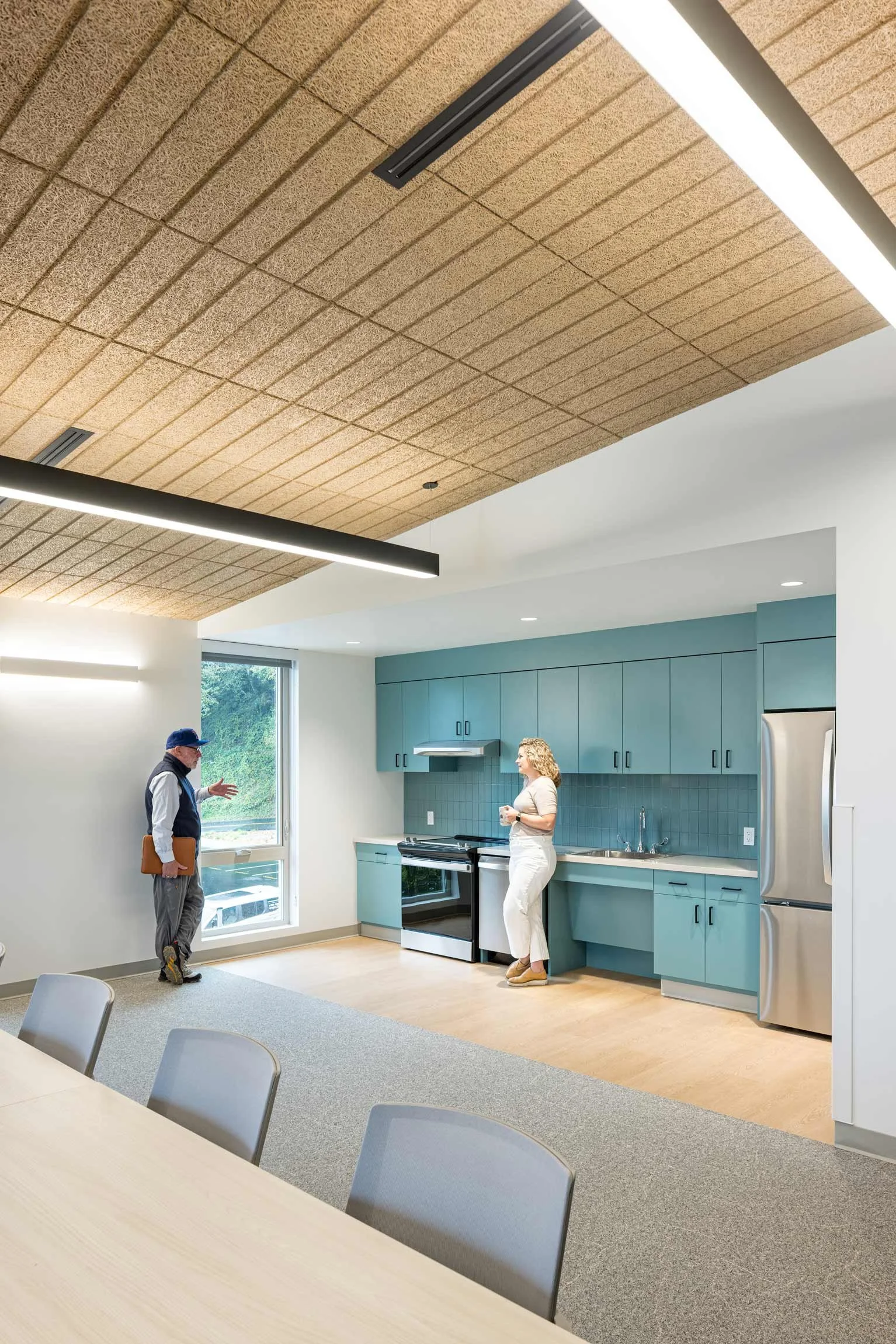 Staff in breakroom with light blue cabinetry in kitchen
