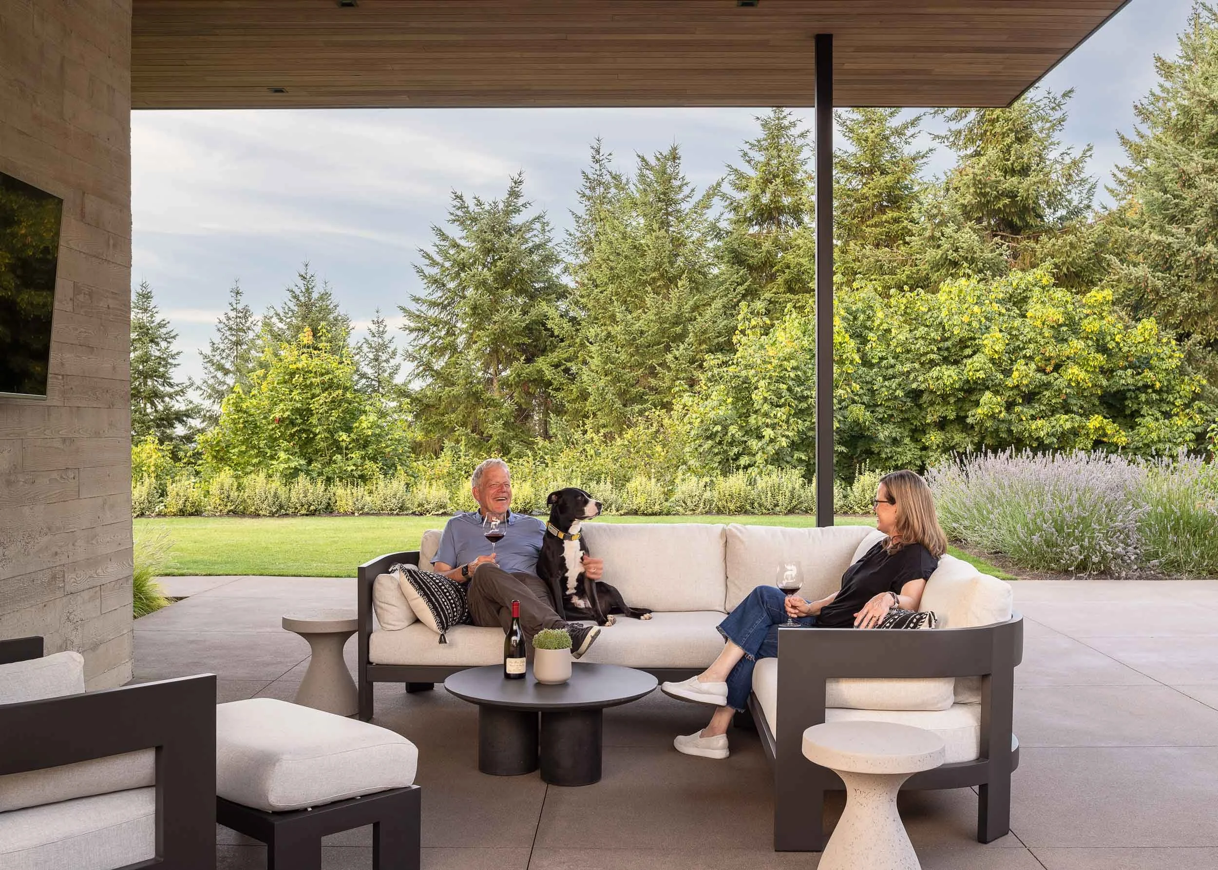 Two people enjoying back covered patio