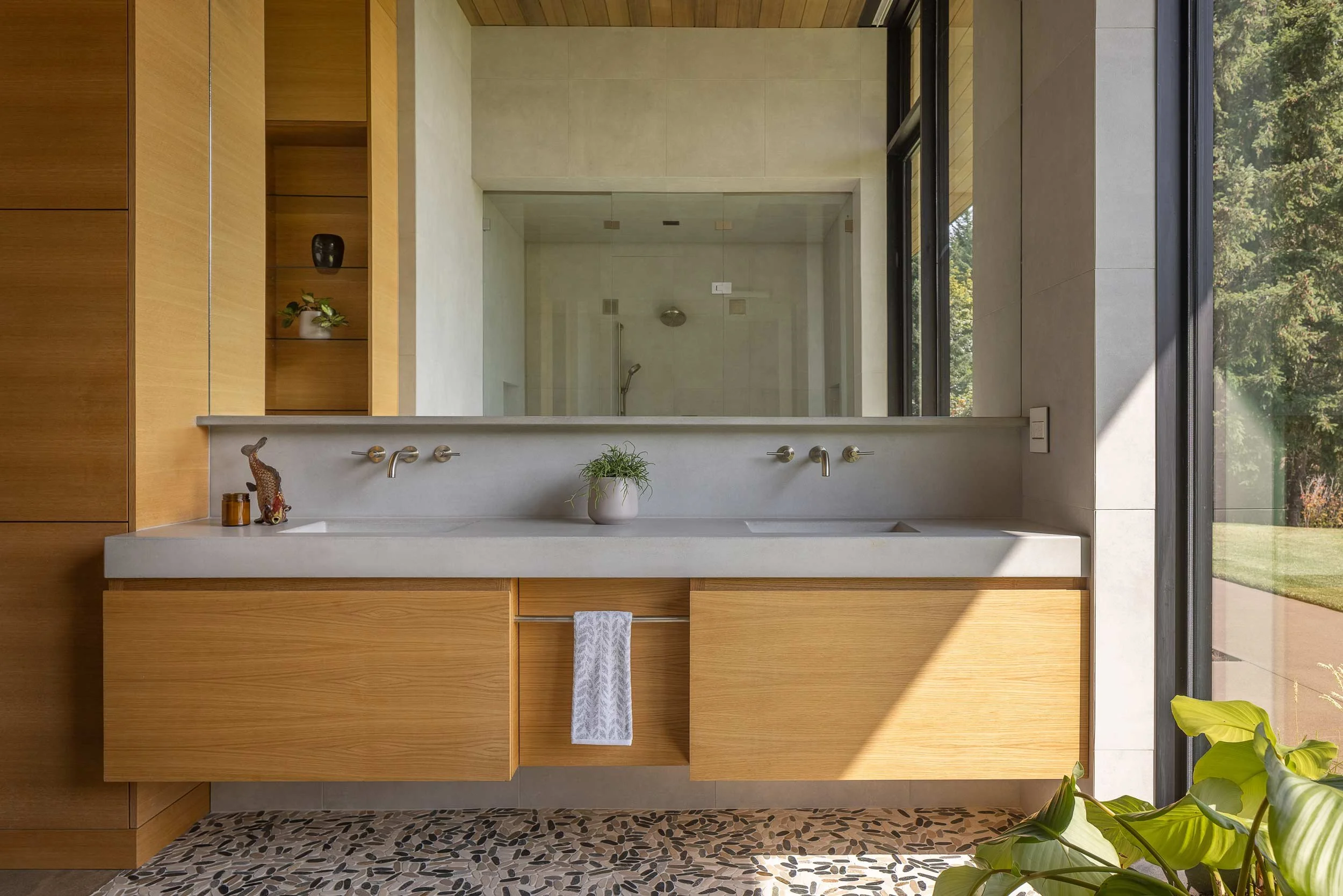 Bathroom with wooden cabinets and large mirror