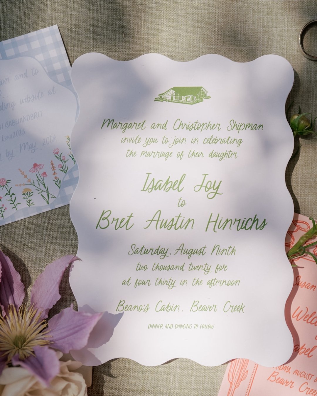 isabel &amp; bret&rsquo;s wedding invitation feat. extra flair with its wavy edges and venue illustration