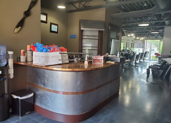 Kennedys barber shop front desk.png
