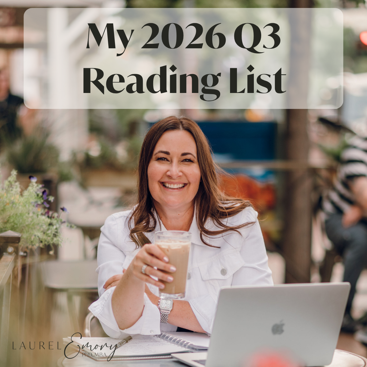 Laurel Emory sitting at a table, with her laptop, holding a glass of tea, smiling at the camera, with the title My 2026 Q3 Reading List.
