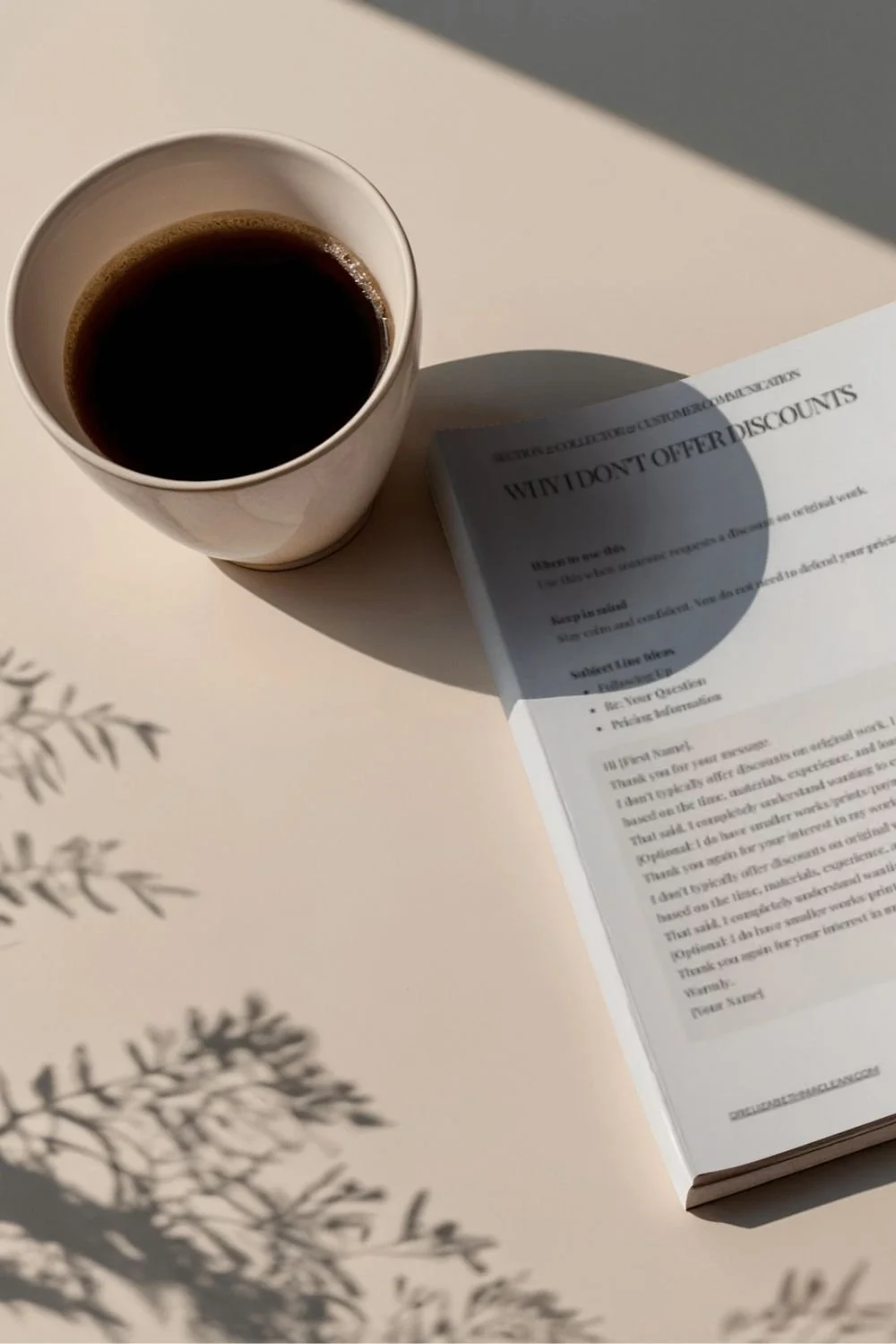 A coffee cup placed near a stack of papers with email template scripts