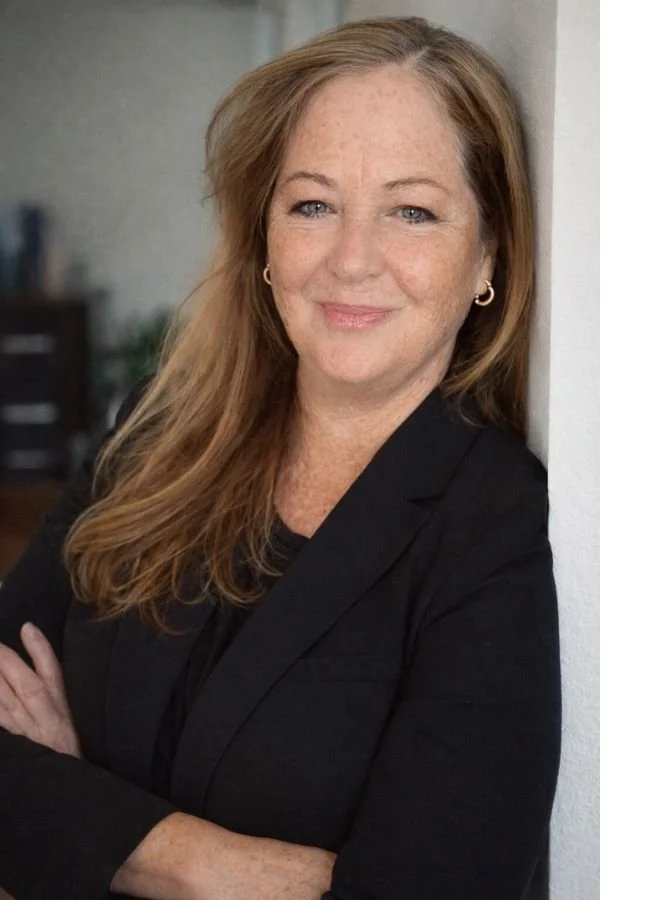 Portrait of a woman leaning against a wall