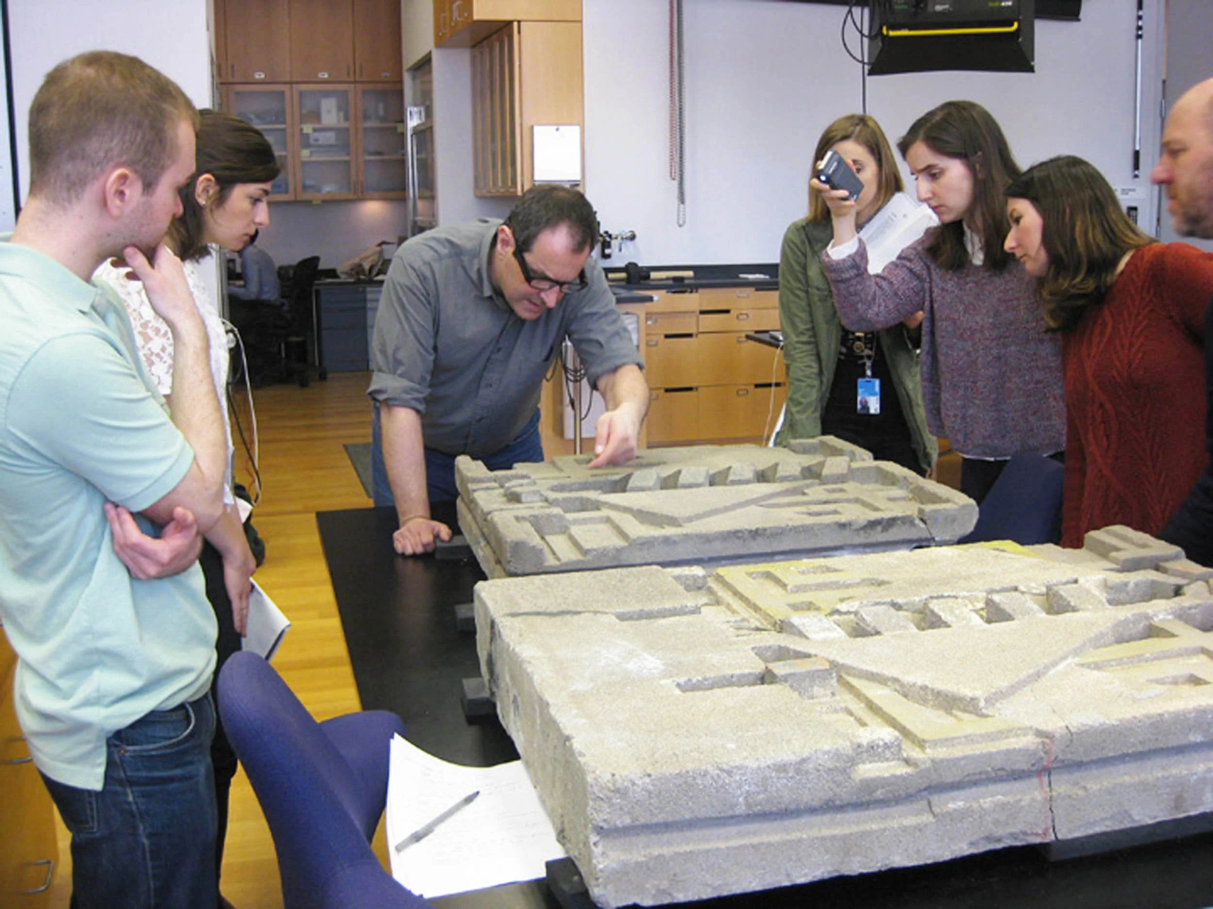 Examining Frank Lloyd Wright textile block with graduate students at the Museum of Modern Art in New York