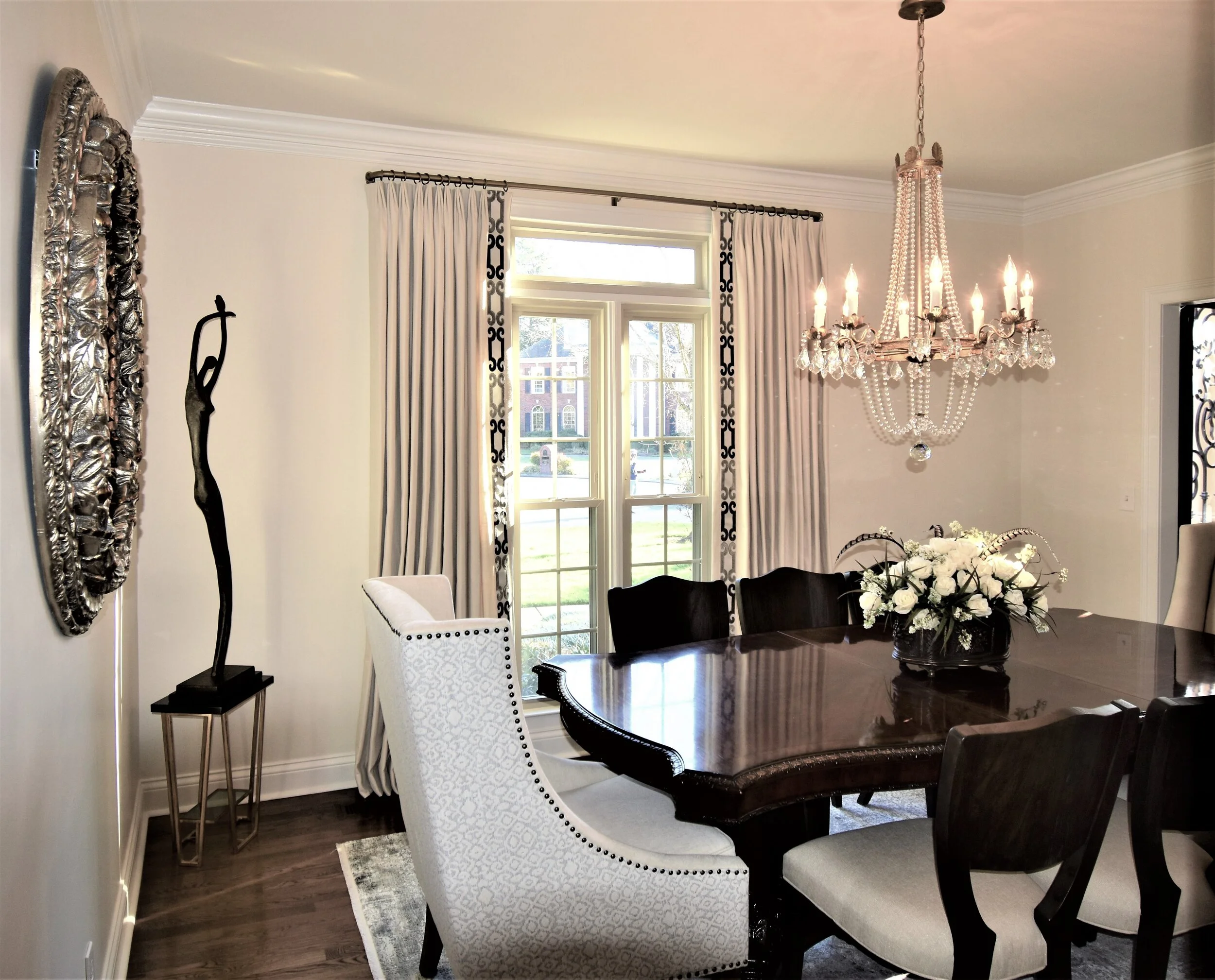 Formal dining room with dark wood table.