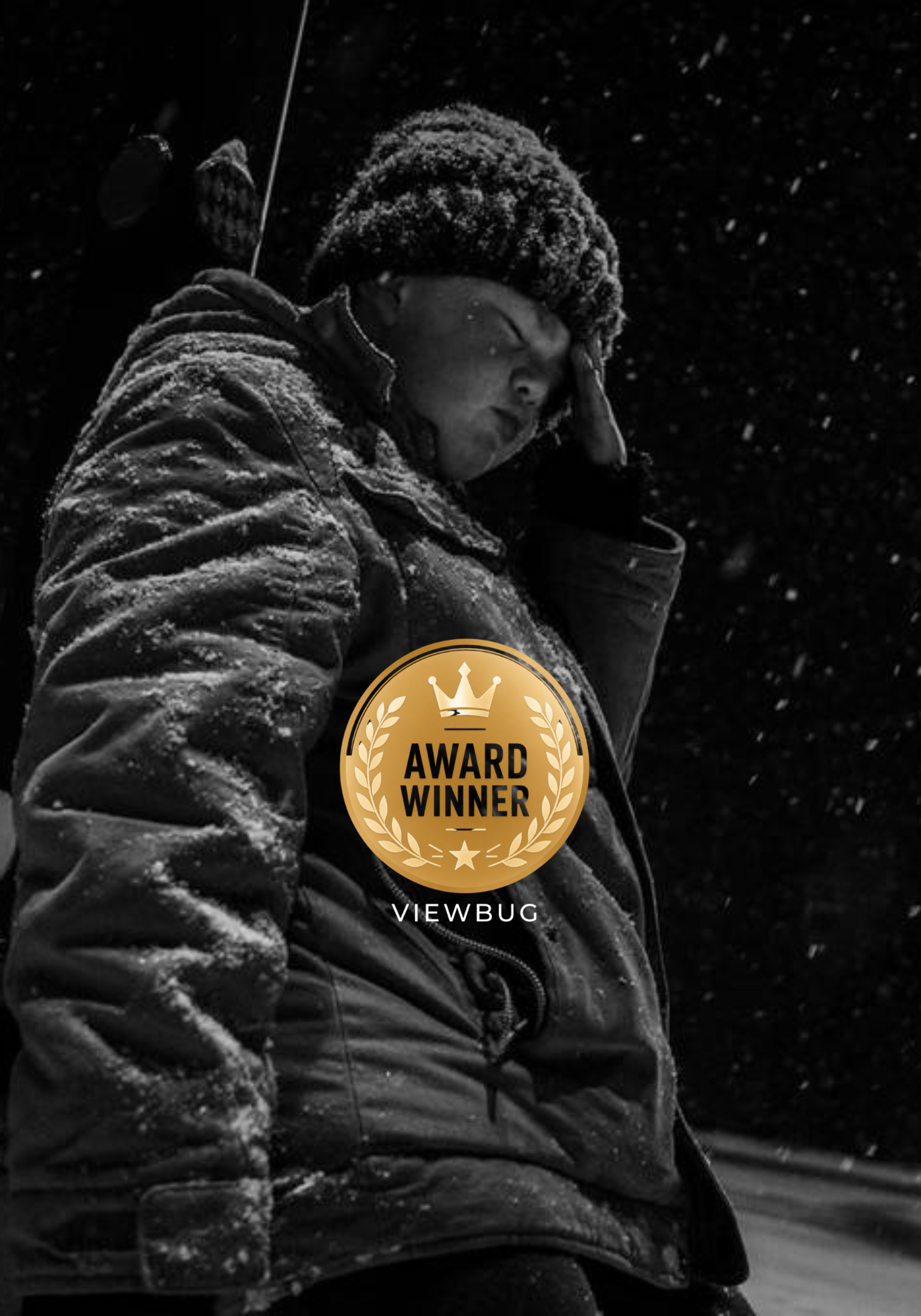 Black and white portrait photograph by Paulette Michelle, recognized as a ViewBug Award Winner — quiet, snow-lit portrait work reflecting her editorial and fine art photography style.