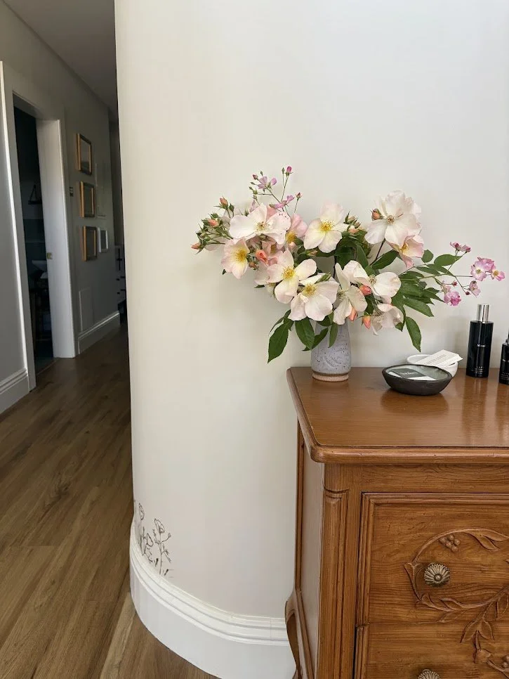 the Soraluna office with fresh roses, business cards, and holistic skincare products