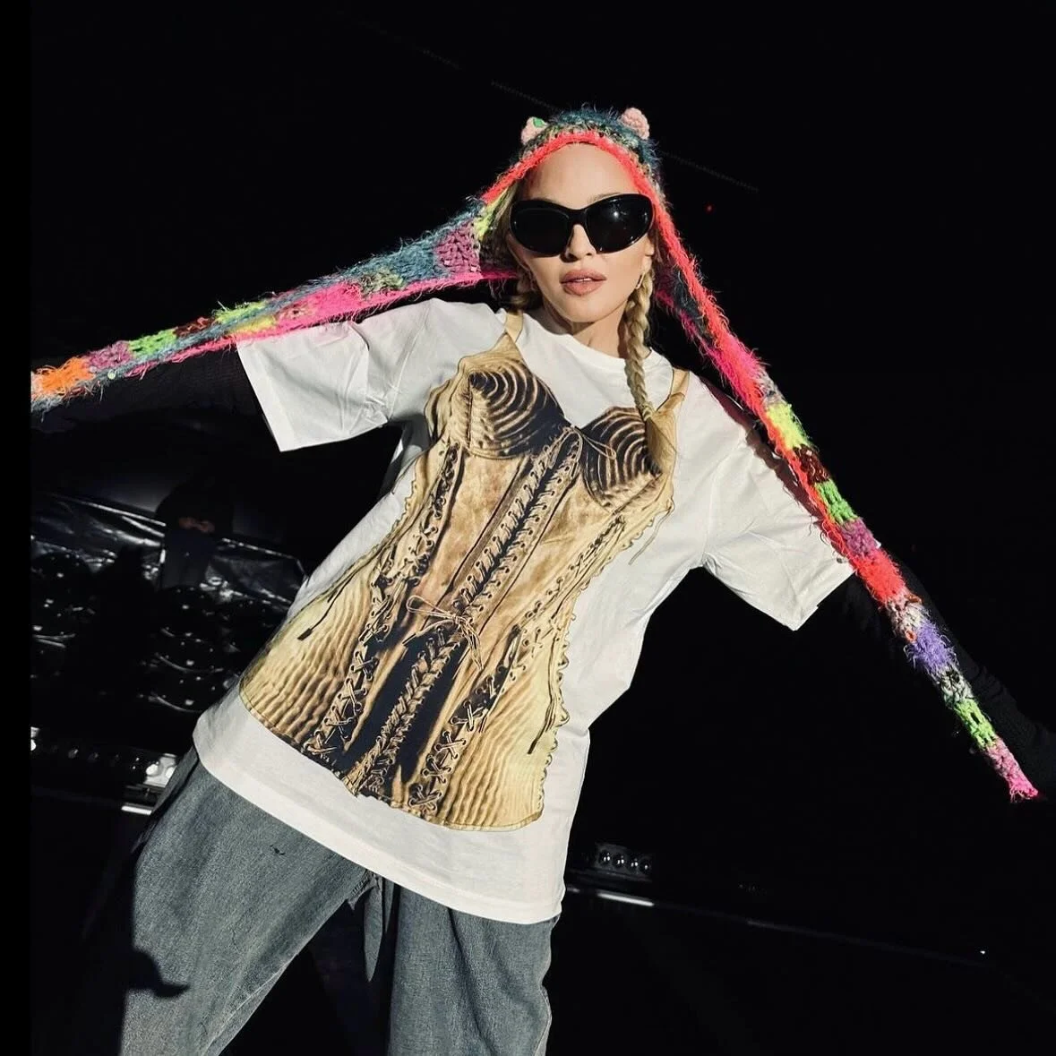 @madonna wearing the new exclusive @jeanpaulgaultier corset-inspired t-shirt, with all proceeds benefiting Raising Malawi. Swipe to see the shirt up-close, and shop now at the link in our story and bio. Purchases of the t-shirts will help support the