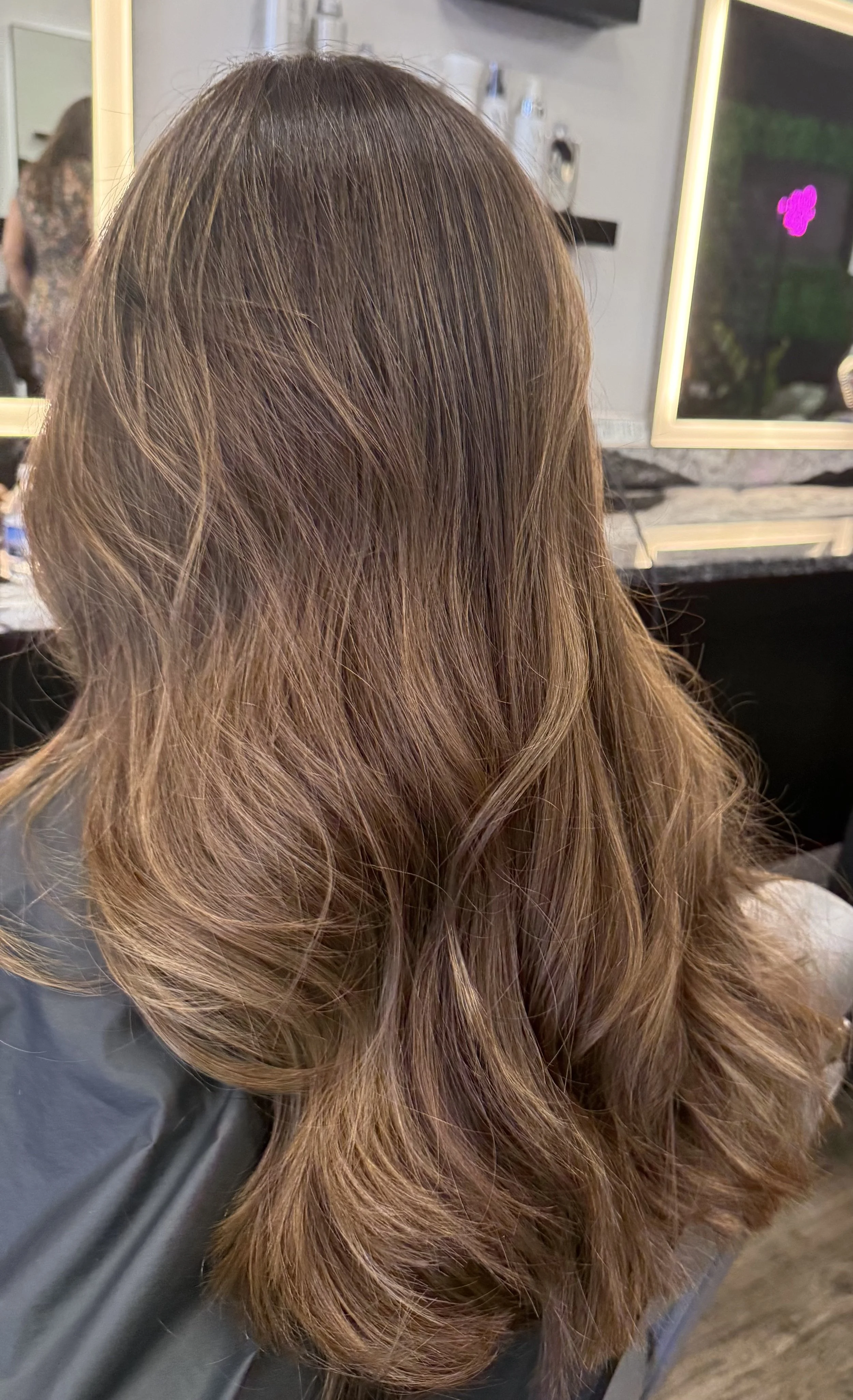  after image features styled, wavy, blonde hair with highlights.