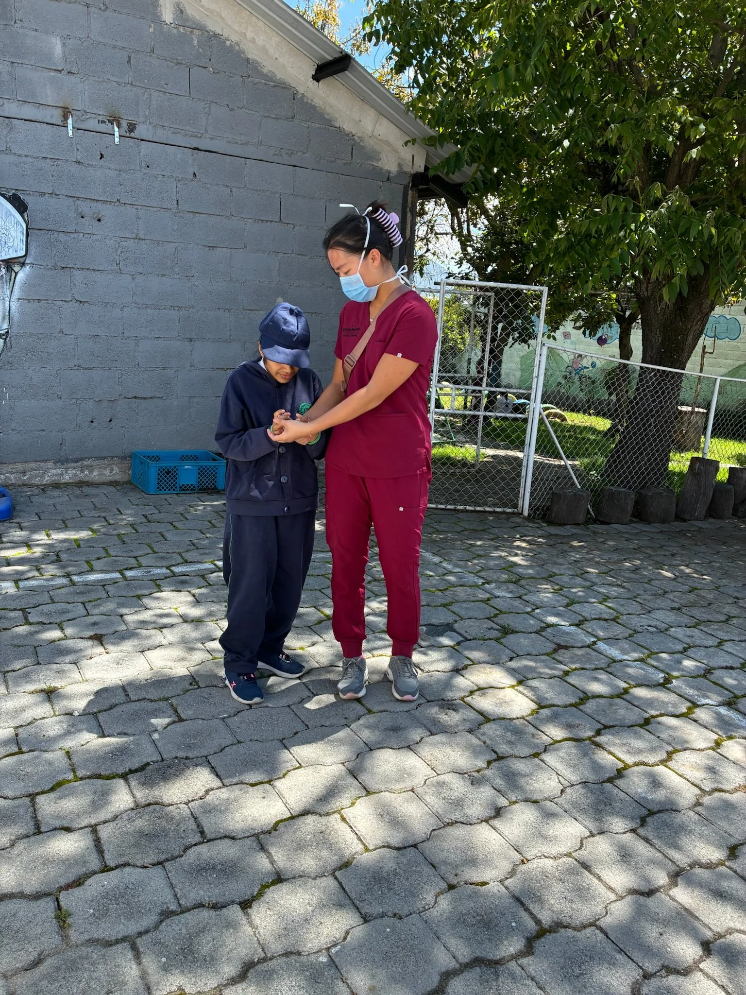 North American nursing student working with a child in Quito Ecuador