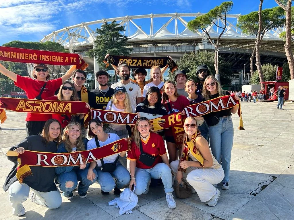 A group photo of study abroad students outside of a futball stadium in Rome Italy.