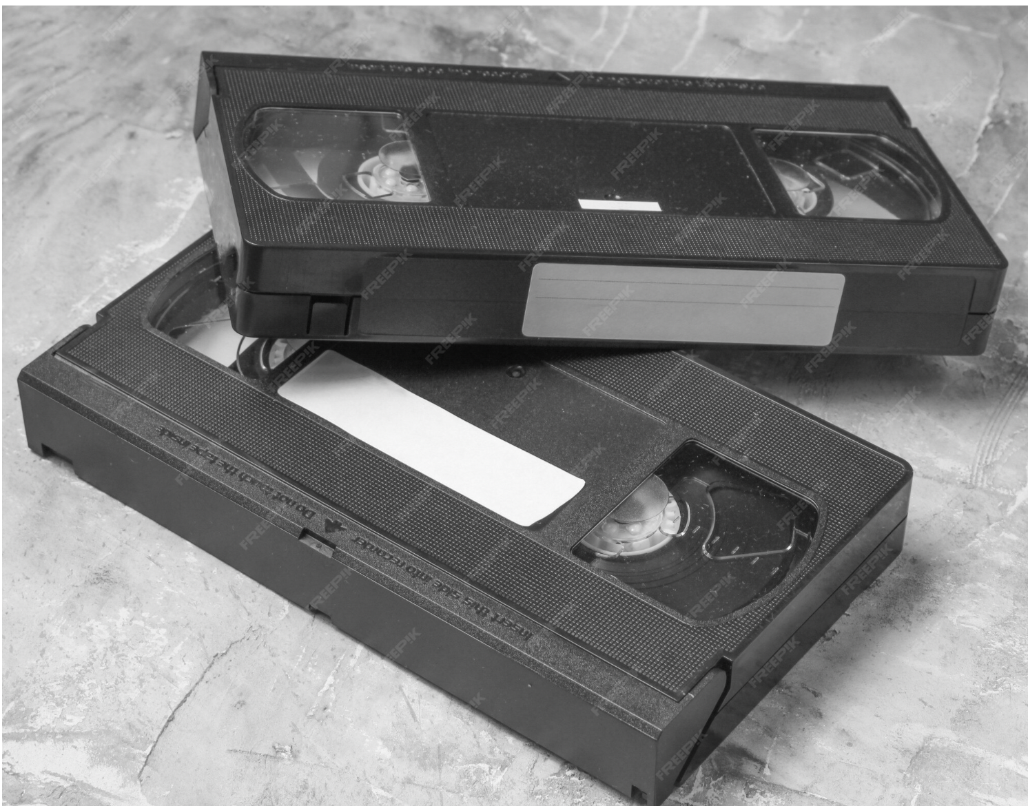 2 black VHS tapes on table