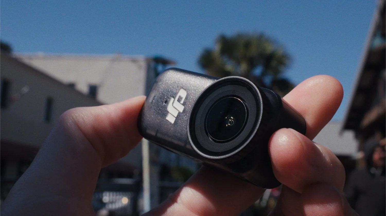 dji osmo nano in hand on a bright, sunny day
