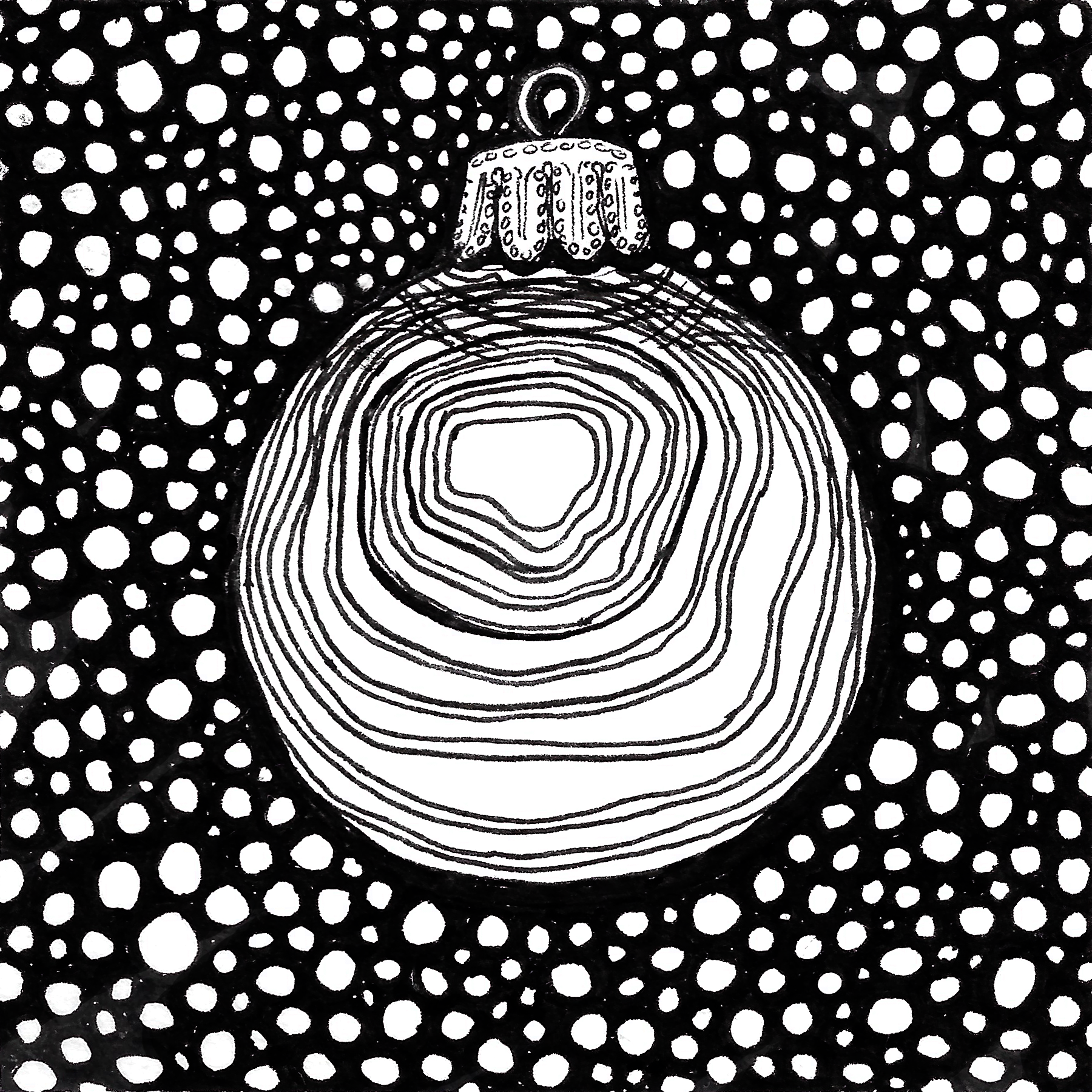 [image description: a round ornament in front of a background of little circles]