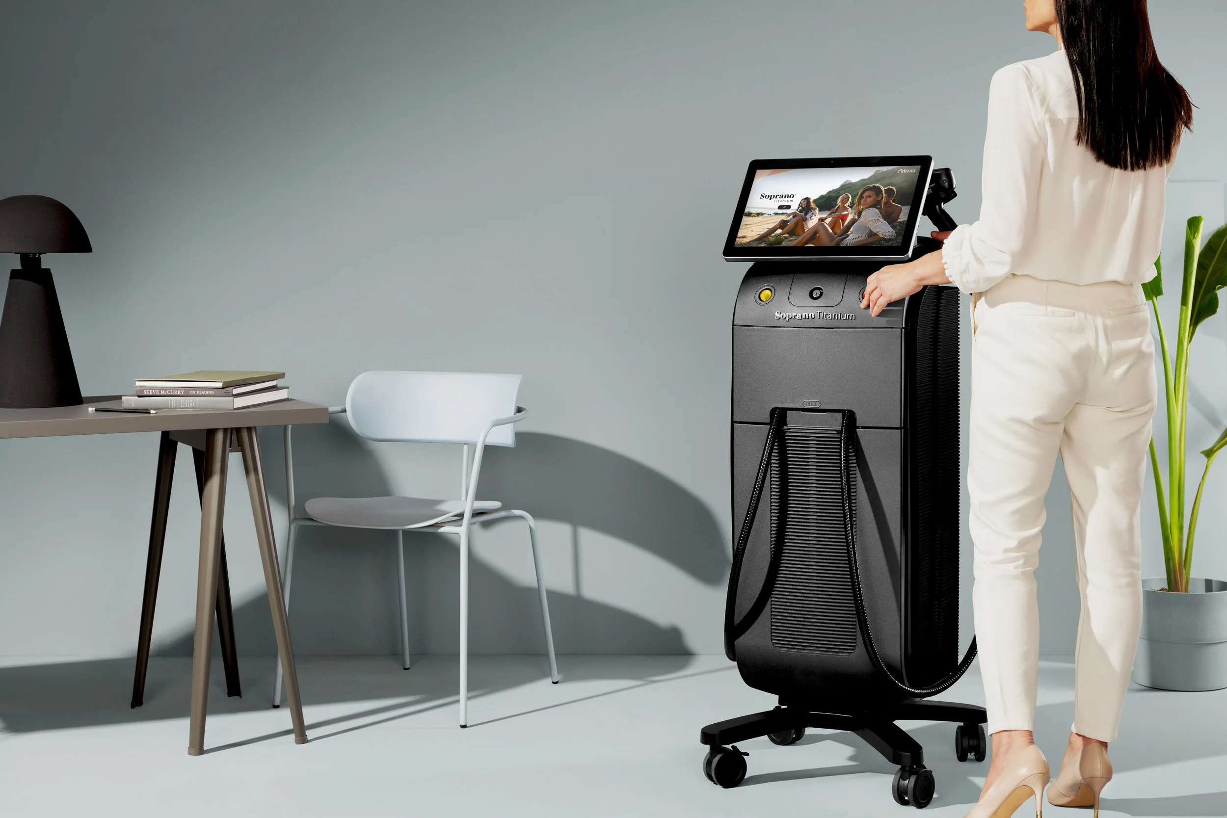 Woman about to use the Alma Soprano Titanium Laser Hair Removal machine.