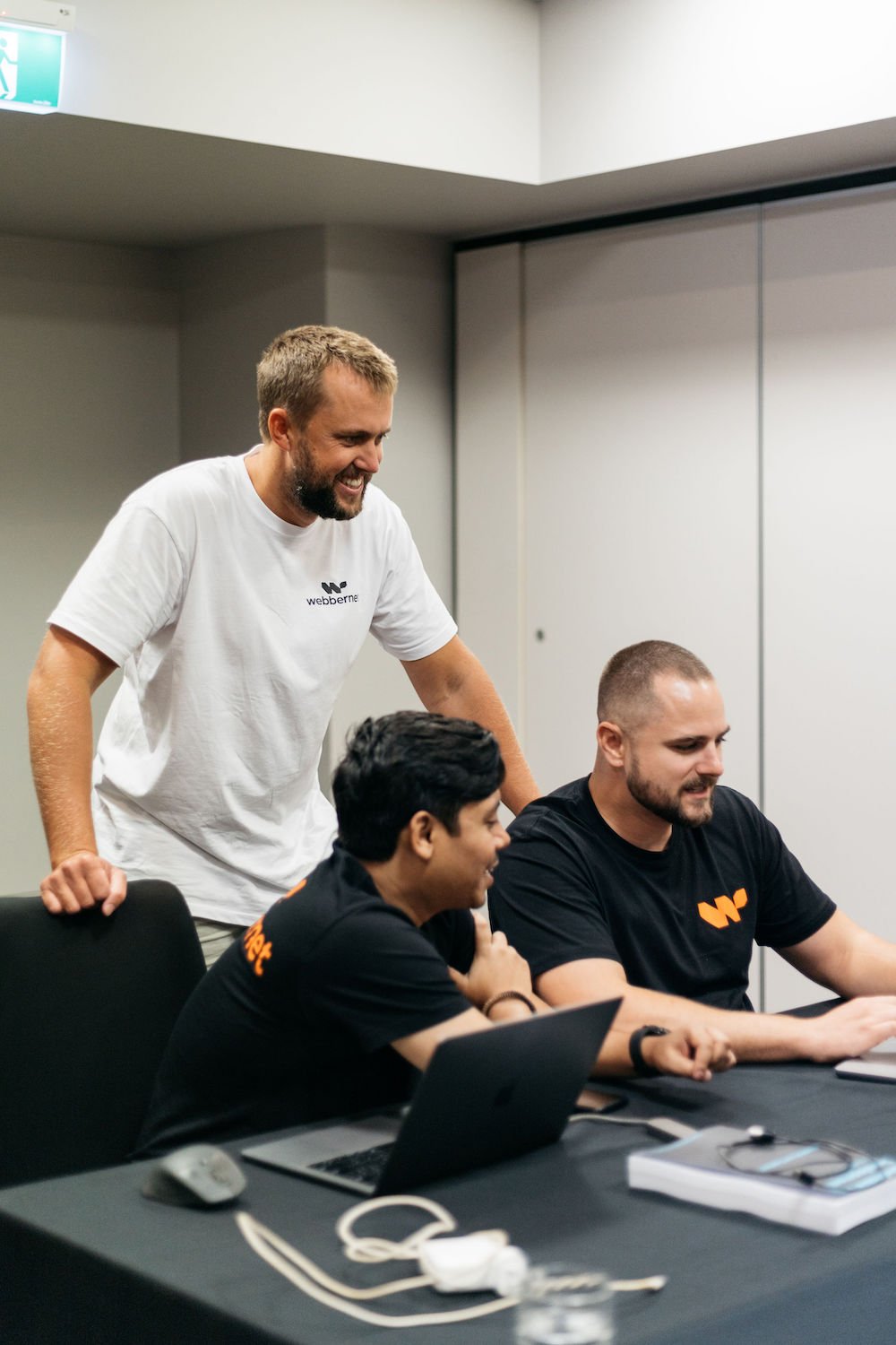 Three Webbernet team members brainstorming and planning a feature on a project