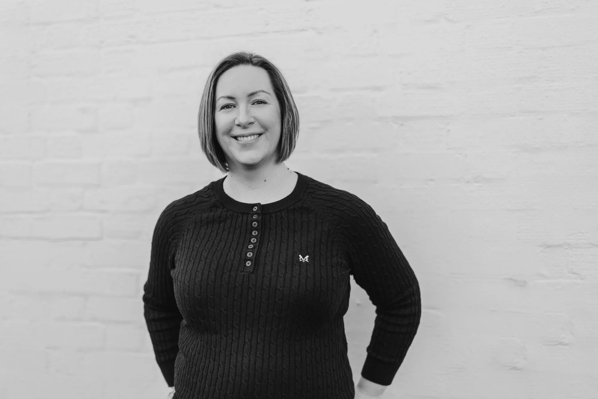 A black and white photo of a woman posing for a photo
